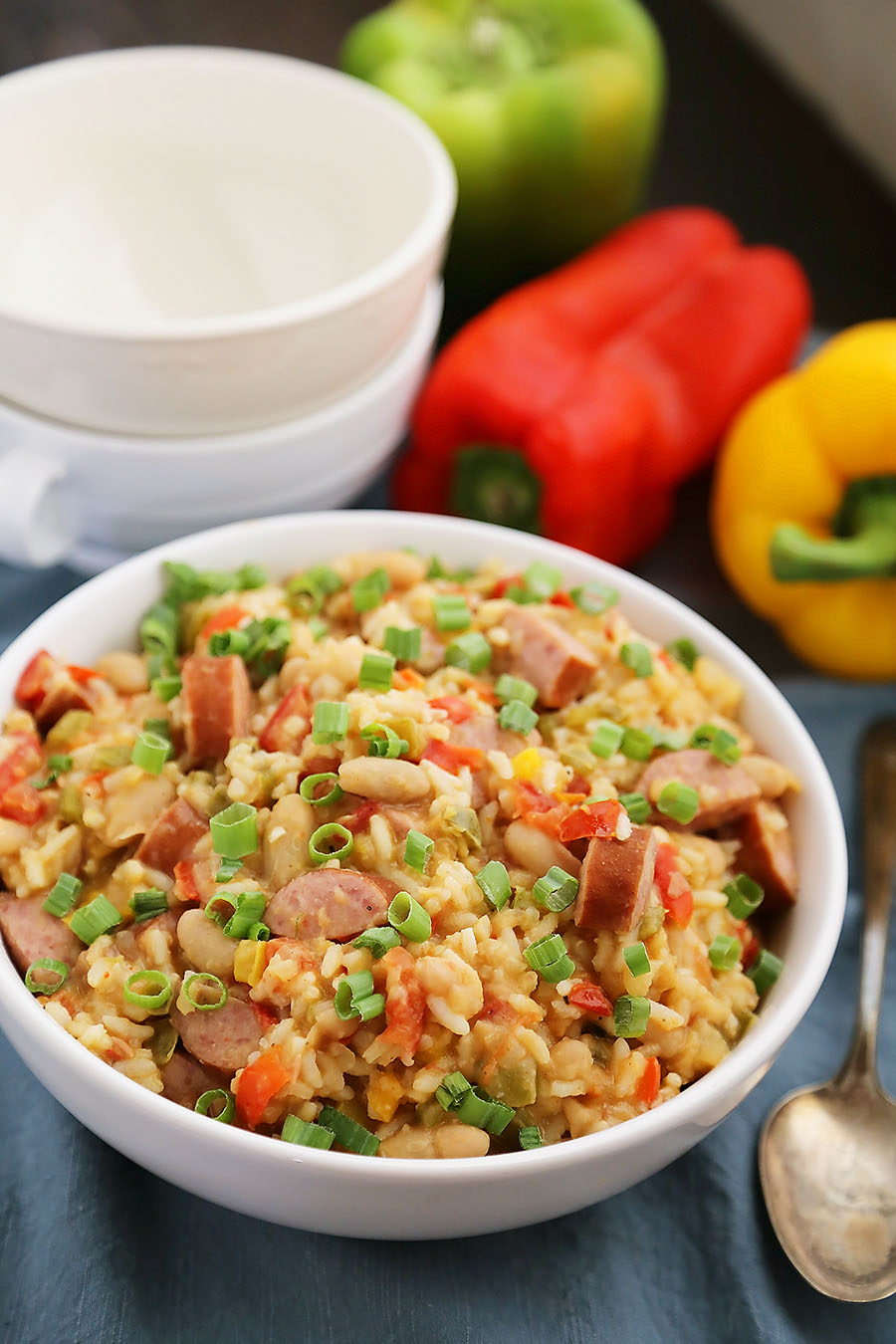 Cajun Sausage, White Bean and Rice Stew - A comforting meal easily cooked on your stovetop! Try this simple spiced Cajun stew with @UncleBensRice, sausage, white beans, tomatoes and bell peppers. thecomfortofcooking.com