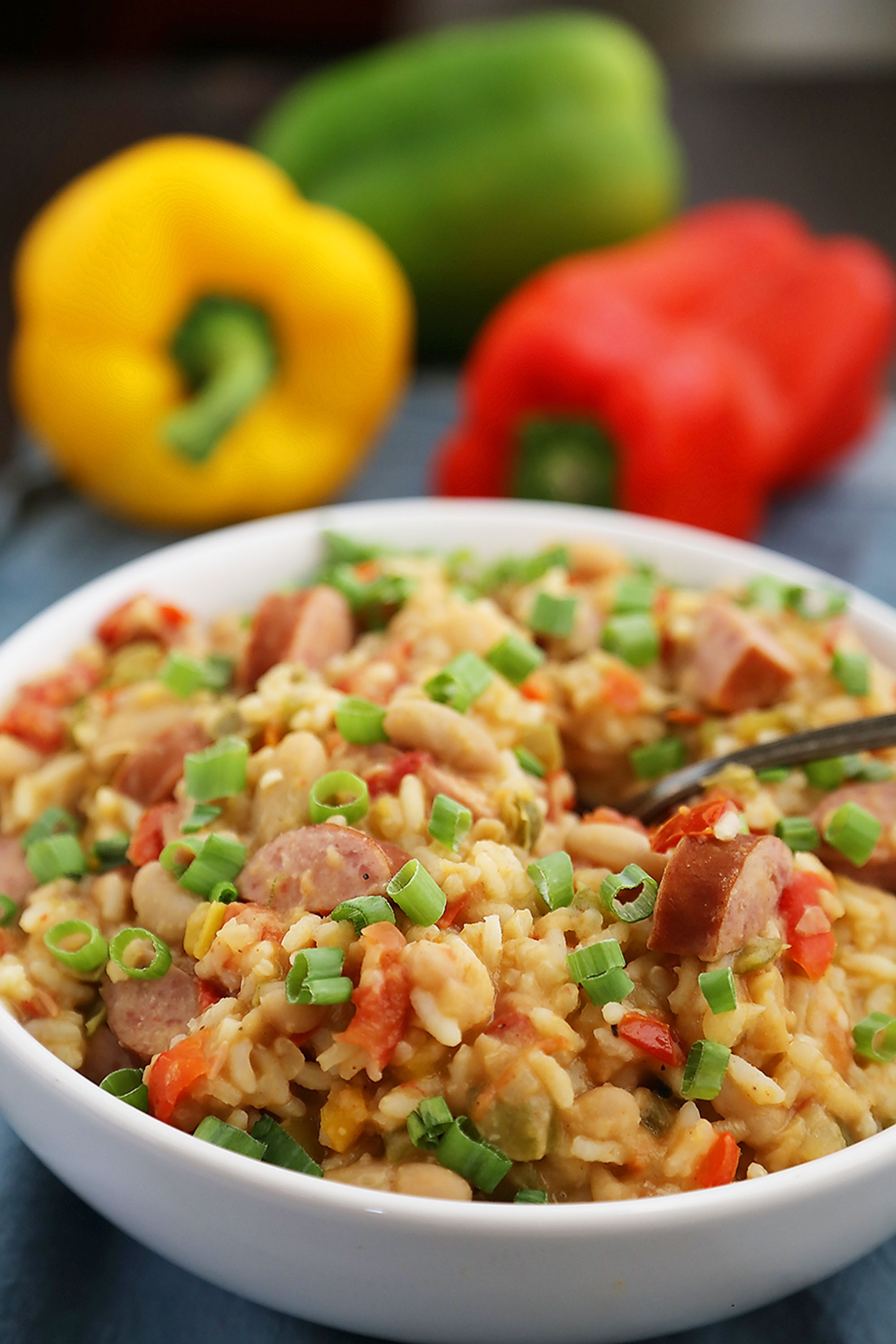 Cajun Sausage, White Bean and Rice Stew - A comforting meal easily cooked on your stovetop! Try this simple spiced Cajun stew with @UncleBensRice, sausage, white beans, tomatoes and bell peppers. thecomfortofcooking.com