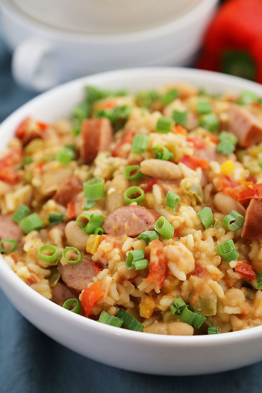 Cajun Sausage, White Bean and Rice Stew - A comforting meal easily cooked on your stovetop! Try this simple spiced Cajun stew with @UncleBensRice, sausage, white beans, tomatoes and bell peppers. thecomfortofcooking.com