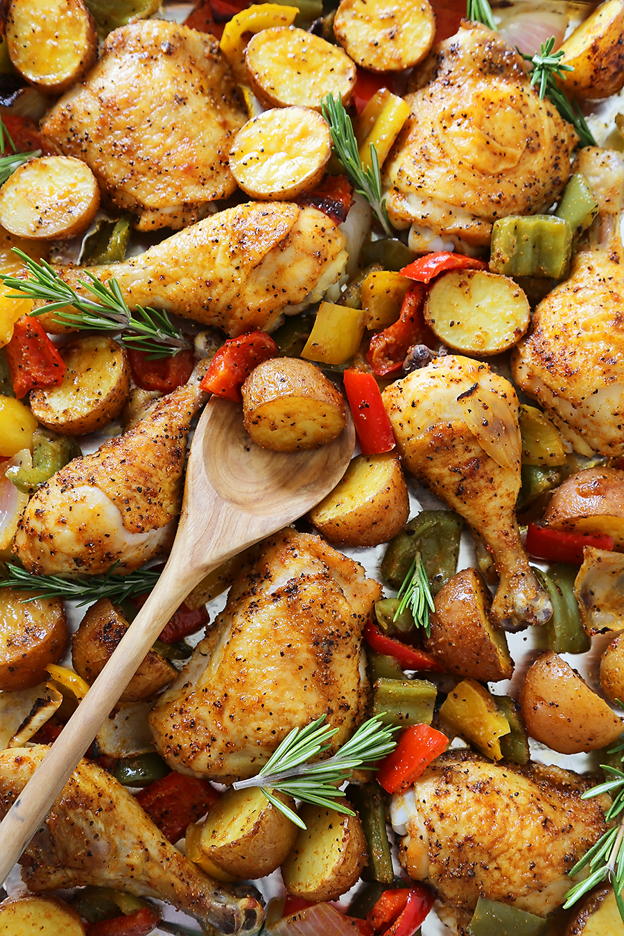 Rosemary Roasted Chicken with Bell Peppers and Potatoes - Crispy, tender roasted chicken with bell peppers, potatoes and onions makes an easy one-pan weeknight meal! Thecomfortofcooking.com