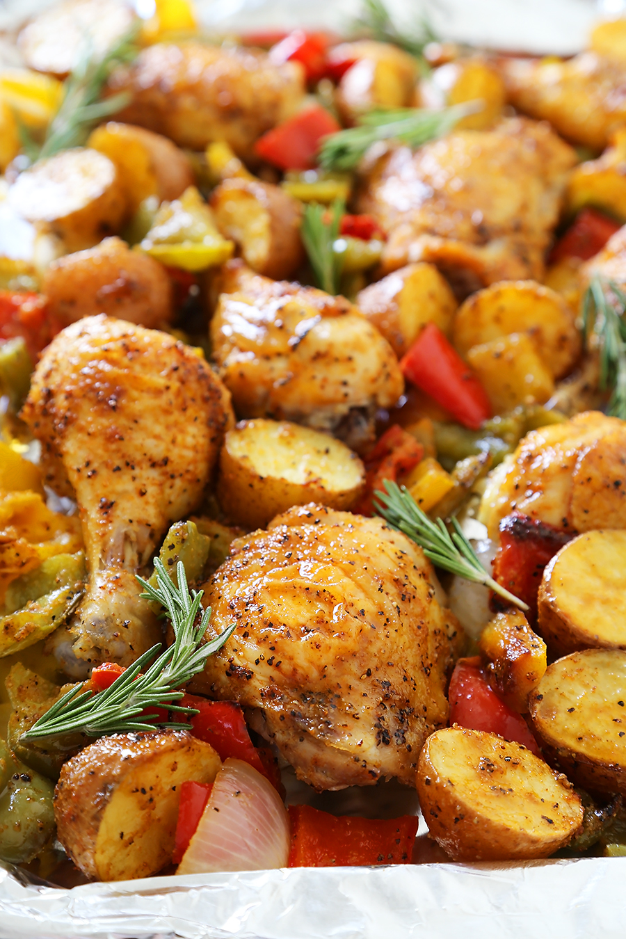 Rosemary Roasted Chicken with Bell Peppers and Potatoes - Crispy, tender roasted chicken with bell peppers, potatoes and onions makes an easy one-pan weeknight meal! Thecomfortofcooking.com