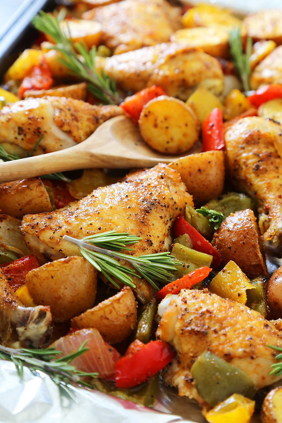 Rosemary Roasted Chicken with Bell Peppers and Potatoes - Crispy, tender roasted chicken with bell peppers, potatoes and onions makes an easy one-pan weeknight meal! Thecomfortofcooking.com
