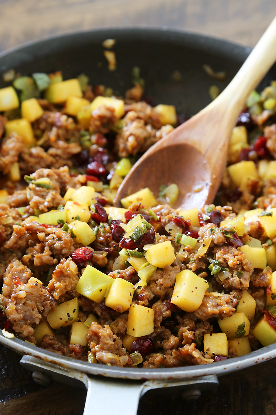 Sausage, Apple and Cranberry Cornbread Stuffing - This savory, delicious stuffing is my all-time favorite comfort food. It's a MUST for Thanksgiving + easy weeknight sides! thecomfortofcooking.com