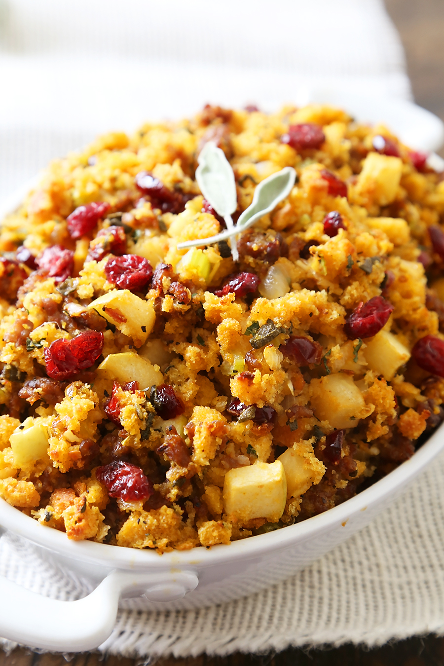Sausage, Apple and Cranberry Cornbread Stuffing - This savory, delicious stuffing is my all-time favorite comfort food. It's a MUST for Thanksgiving + easy weeknight sides! thecomfortofcooking.com