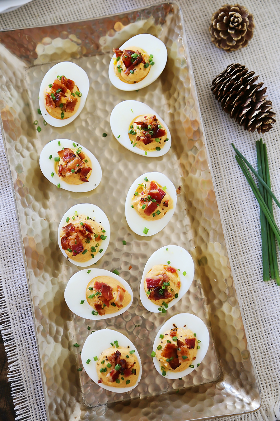 Bacon, Chive + Sour Cream Deviled Eggs - Creamy, crispy and full of flavor! All you need is 20 minutes and a handful of ingredients for the perfect party bite! thecomfortofcooking.com