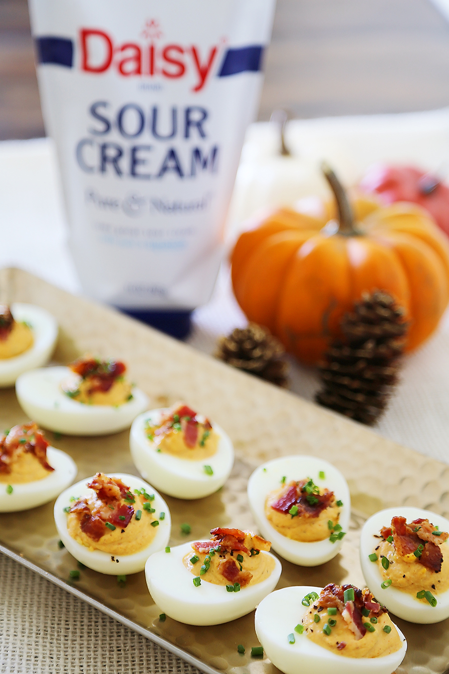 Bacon, Chive + Sour Cream Deviled Eggs - Creamy, crispy and full of flavor! All you need is 20 minutes and a handful of ingredients for the perfect party bite! thecomfortofcooking.com