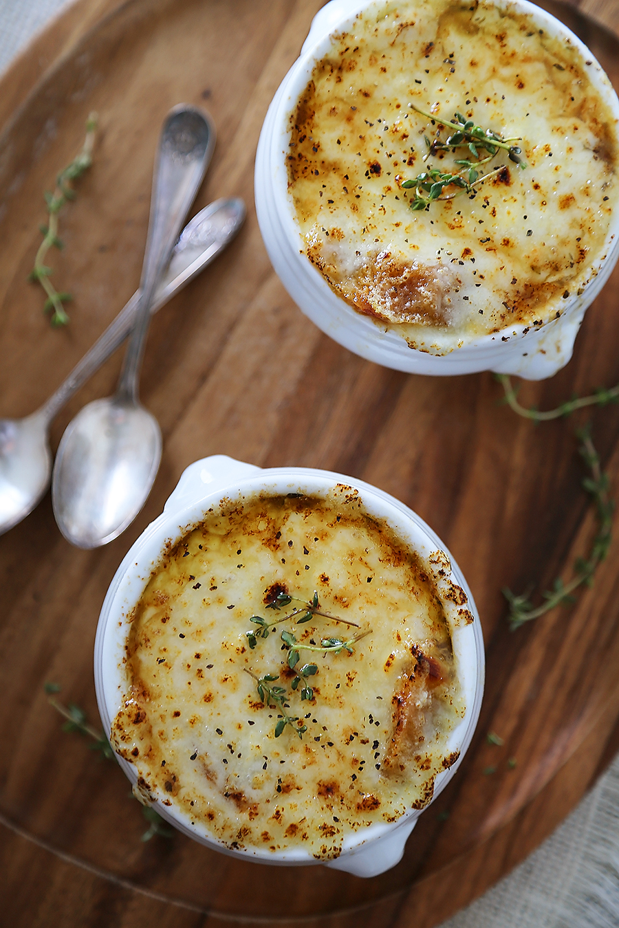 Easy French Onion Soup - Fragrant, cheesy and so comforting! Caramelized onions, beef stock and white (or red) cooking wine mingle into a luxurious medley in this classic French dish. Thecomfortofcooking.com