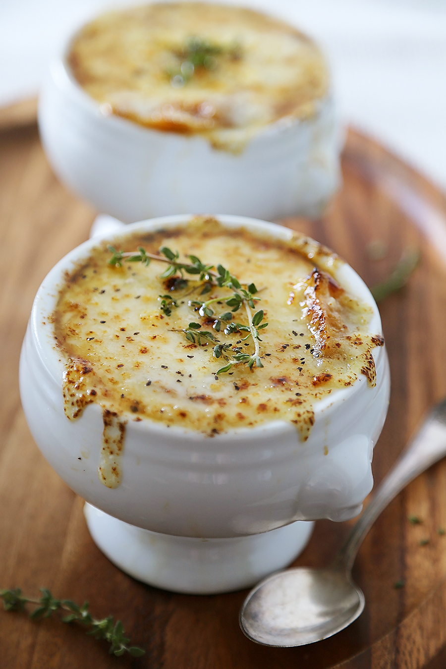 Easy French Onion Soup - Fragrant, cheesy and so comforting! Caramelized onions, beef stock and white (or red) cooking wine mingle into a luxurious medley in this classic French dish. Thecomfortofcooking.com