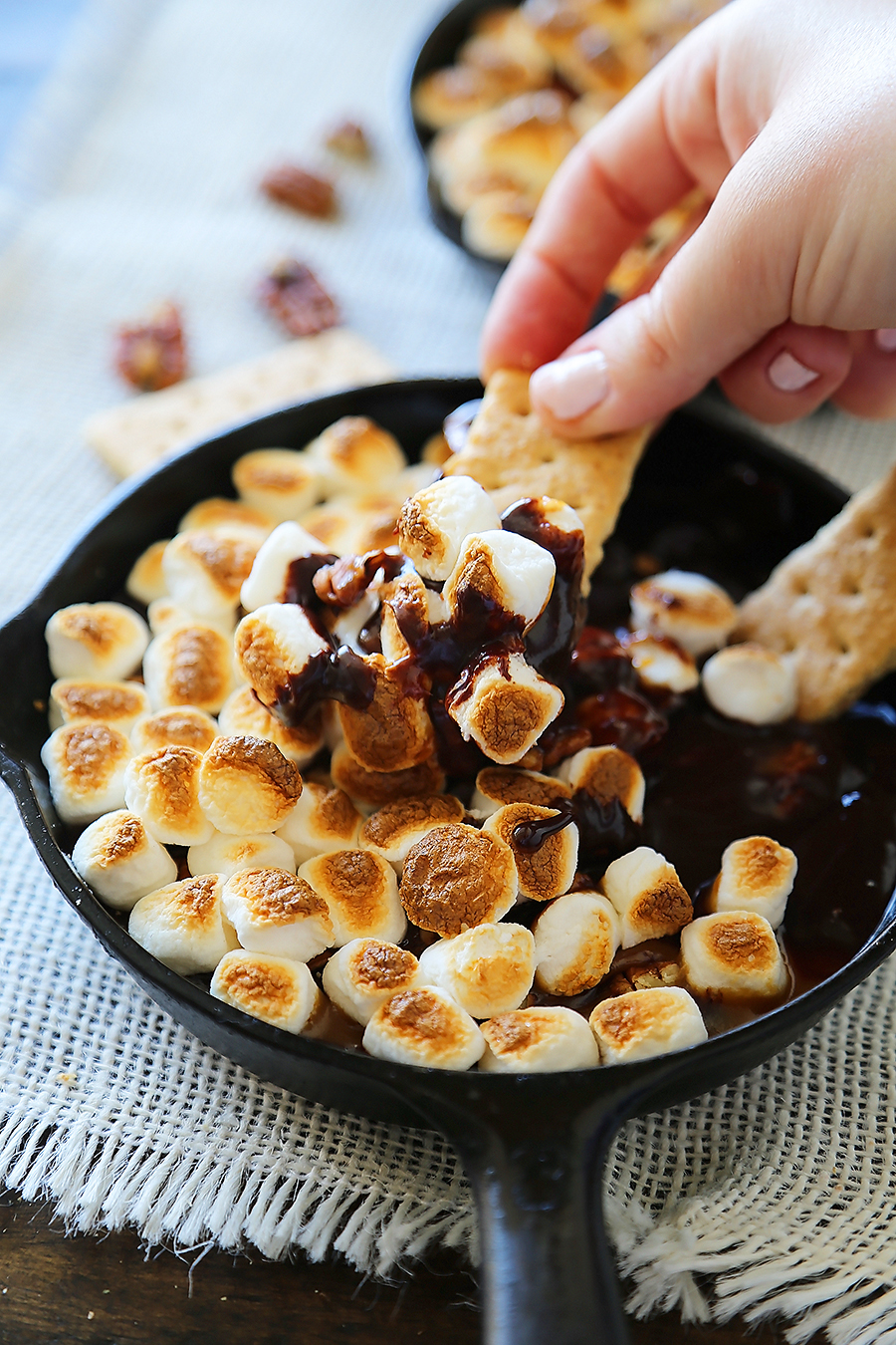 5-Ingredient Caramel Pecan S'mores Dip - Perfect for parties! Loaded with creamy caramel and pecans, this treat is super quick and easy! thecomfortofcooking.com