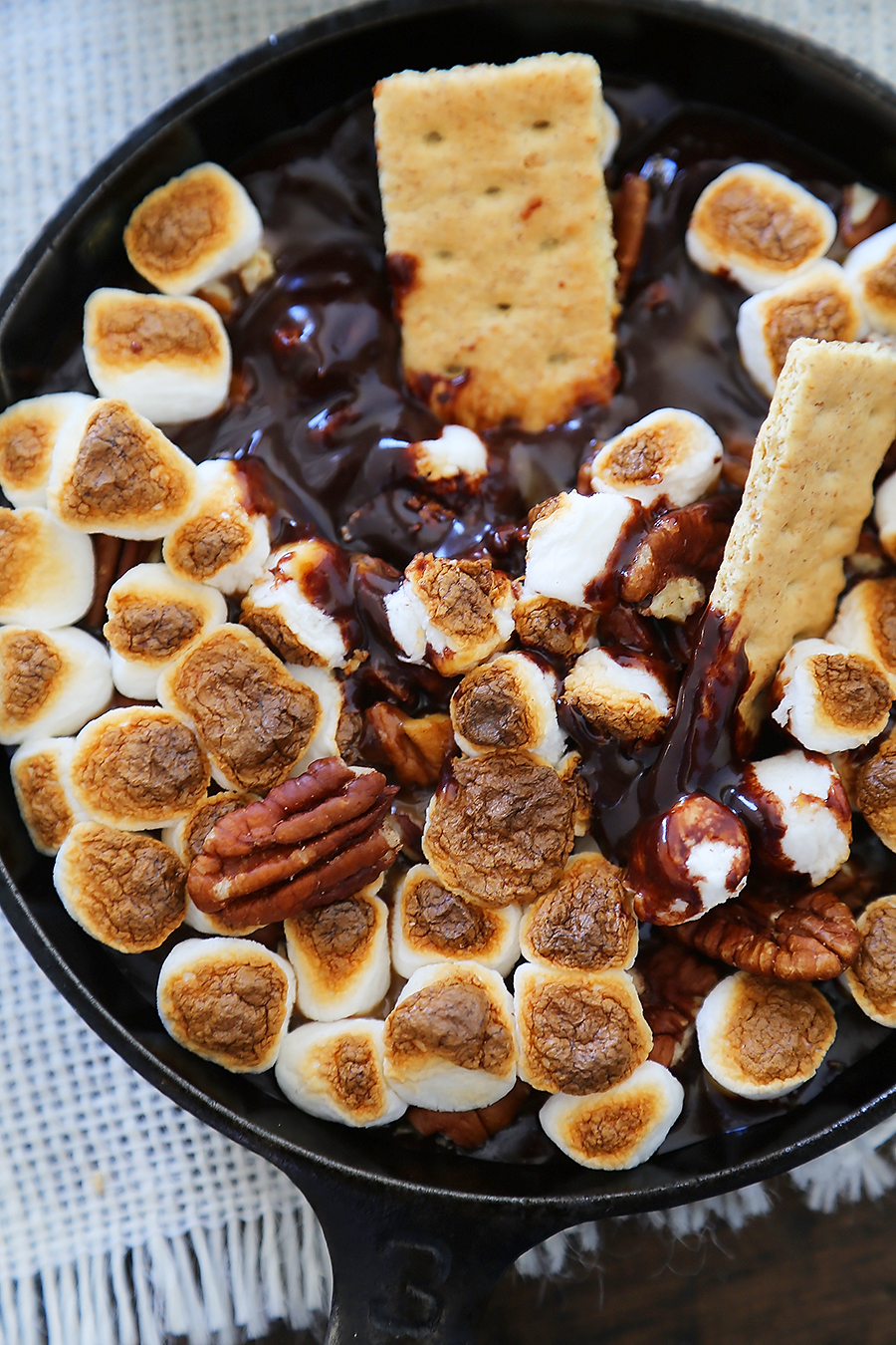 5-Ingredient Caramel Pecan S'mores Dip - Perfect for parties! Loaded with creamy caramel and pecans, this treat is super quick and easy! thecomfortofcooking.com