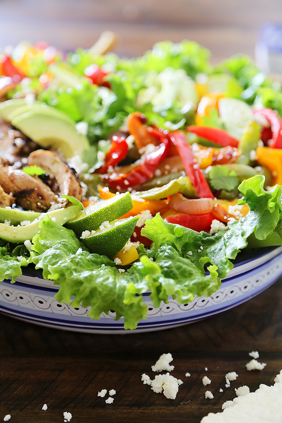 Grilled Chili-Lime Chicken Fajita Salad - Tender, juicy marinated chicken with fresh bell peppers, onions, garlic and avocado slices. SO good. Top with some creamy queso fresco and cilantro for extra eye appeal and flavor! thecomfortofcooking.com