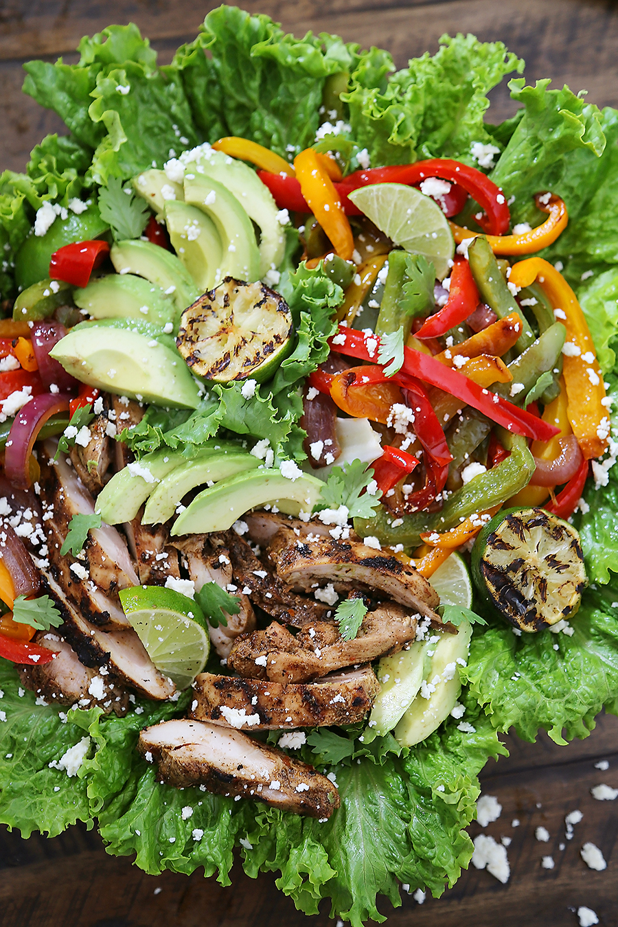 Grilled Chili-Lime Chicken Fajita Salad - Tender, juicy marinated chicken with fresh bell peppers, onions, garlic and avocado slices. SO good. Top with some creamy queso fresco and cilantro for extra eye appeal and flavor! thecomfortofcooking.com