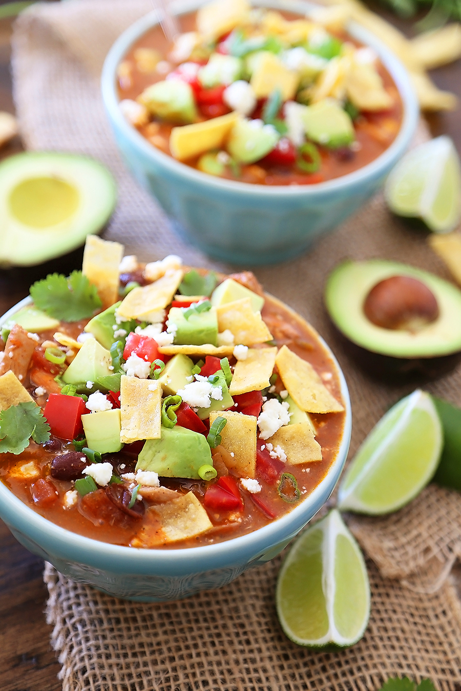 Easy Chicken Tortilla Soup - Serve this spicy, citrusy chicken tortilla soup for a fun twist on your weeknight meals! Add crunchy baked or fried tortilla strips (recipe included), cilantro, avocado and crumbled queso for a truly amazing soup! Thecomfortofcooking.com