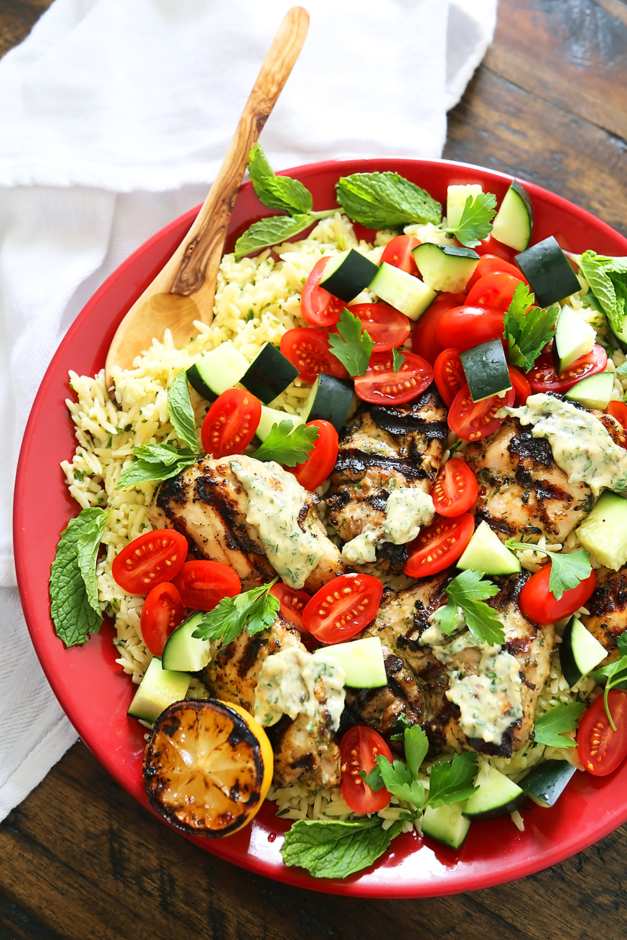 Greek Tahini Chicken with Cucumber, Tomato and Lemon Orzo Salad - Smoky, tender marinated chicken thighs with a creamy tahini sauce, fresh veggies, orzo and a squeeze of lemon! Full of nutritious, hearty goodness! Thecomfortofcooking.com