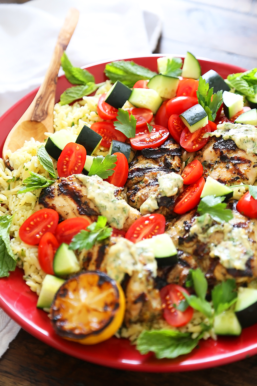 Greek Tahini Chicken with Cucumber, Tomato and Lemon Orzo Salad - Smoky, tender marinated chicken thighs with a creamy tahini sauce, fresh veggies, orzo and a squeeze of lemon! Full of nutritious, hearty goodness! Thecomfortofcooking.com