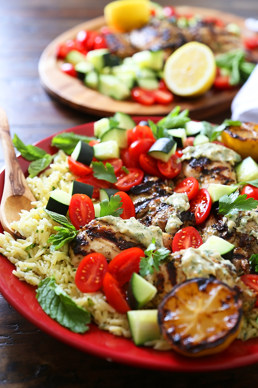 Greek Tahini Chicken with Cucumber, Tomato and Lemon Orzo Salad - Smoky, tender marinated chicken thighs with a creamy tahini sauce, fresh veggies, orzo and a squeeze of lemon! Full of nutritious, hearty goodness! Thecomfortofcooking.com