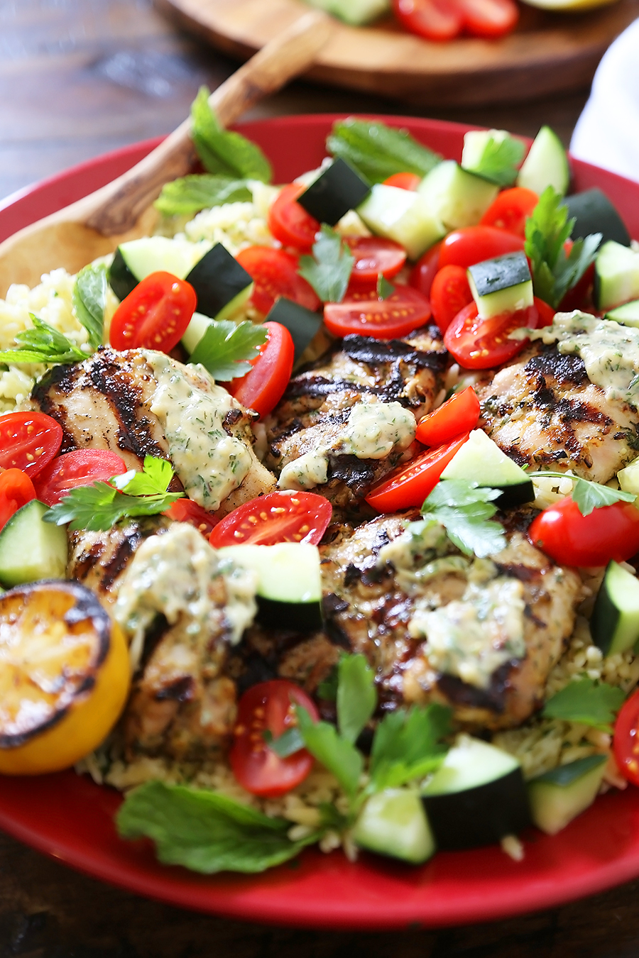 Greek Tahini Chicken with Cucumber, Tomato and Lemon Orzo Salad - Smoky, tender marinated chicken thighs with a creamy tahini sauce, fresh veggies, orzo and a squeeze of lemon! Full of nutritious, hearty goodness! Thecomfortofcooking.com