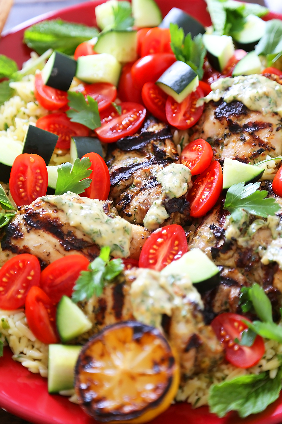 Greek Tahini Chicken with Cucumber, Tomato and Lemon Orzo Salad - Smoky, tender marinated chicken thighs with a creamy tahini sauce, fresh veggies, orzo and a squeeze of lemon! Full of nutritious, hearty goodness! Thecomfortofcooking.com