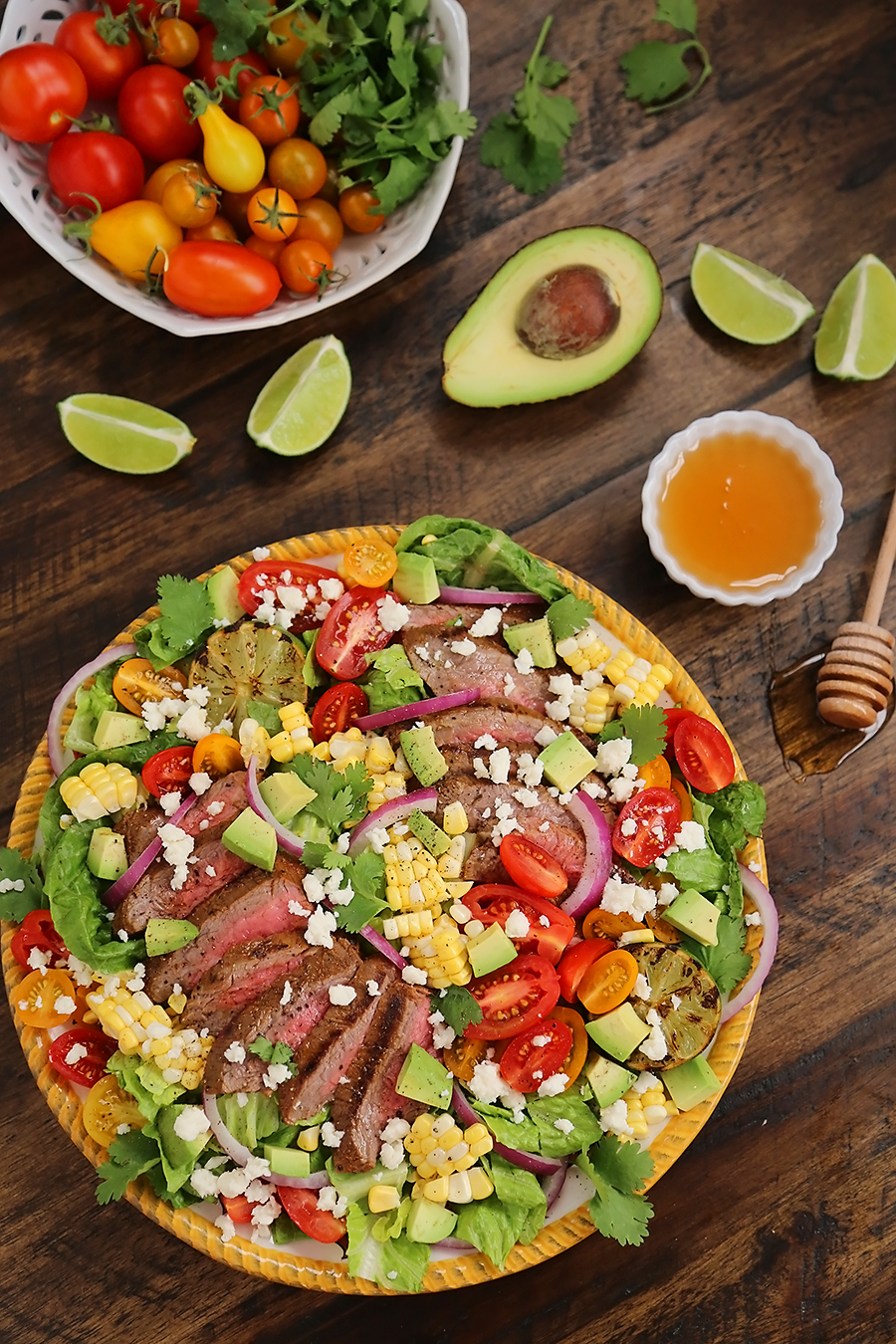 Mexican Grilled Steak Salad with Honey Lime Dressing - Smoky, spicy steak, fresh corn, red onions, creamy avocado and a zesty honey lime dressing. Full of flavor, color and nutritious goodness! Thecomfortofcooking.com