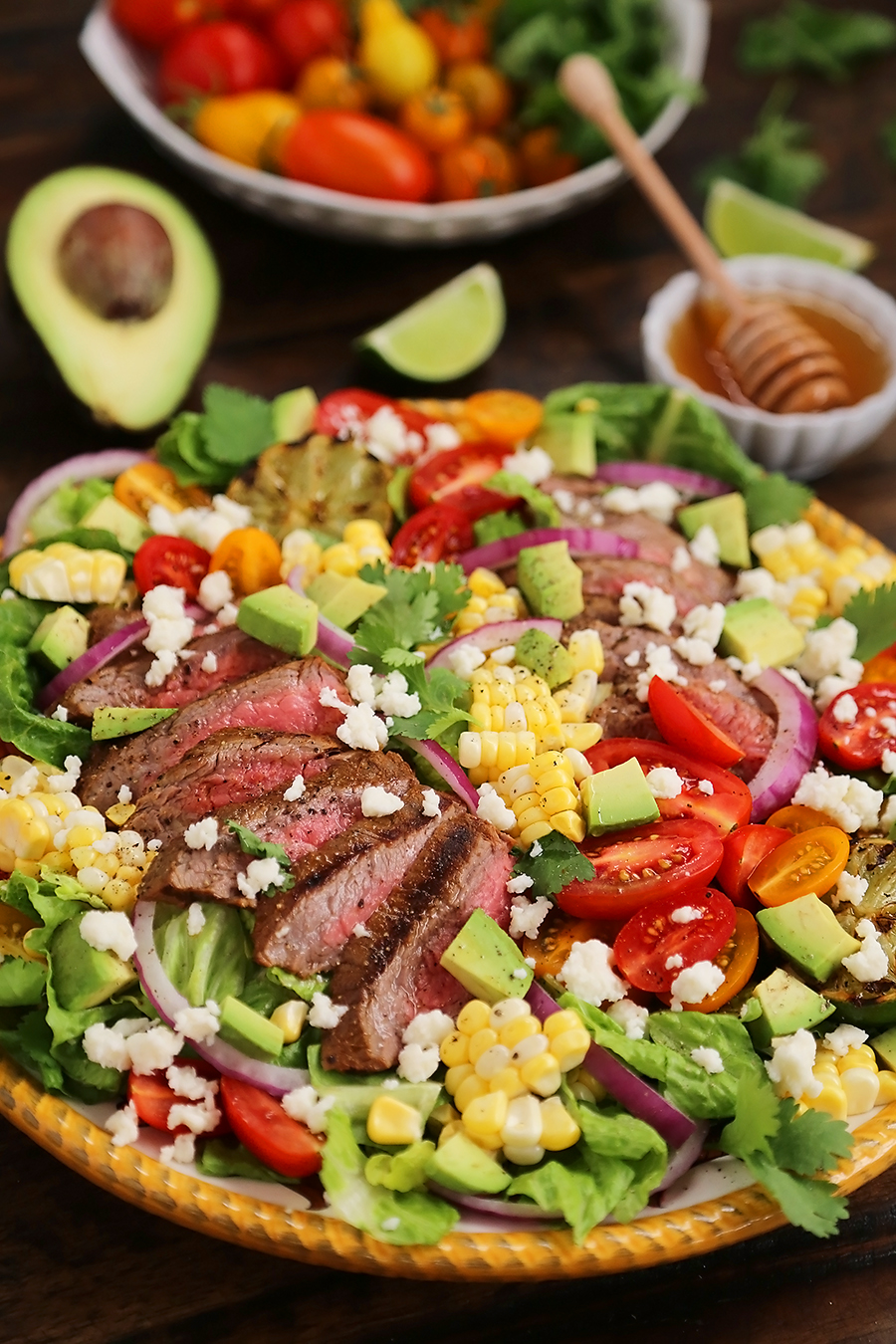 Mexican Grilled Steak Salad with Honey Lime Dressing - Smoky, spicy steak, fresh corn, red onions, creamy avocado and a zesty honey lime dressing. Full of flavor, color and nutritious goodness! Thecomfortofcooking.com