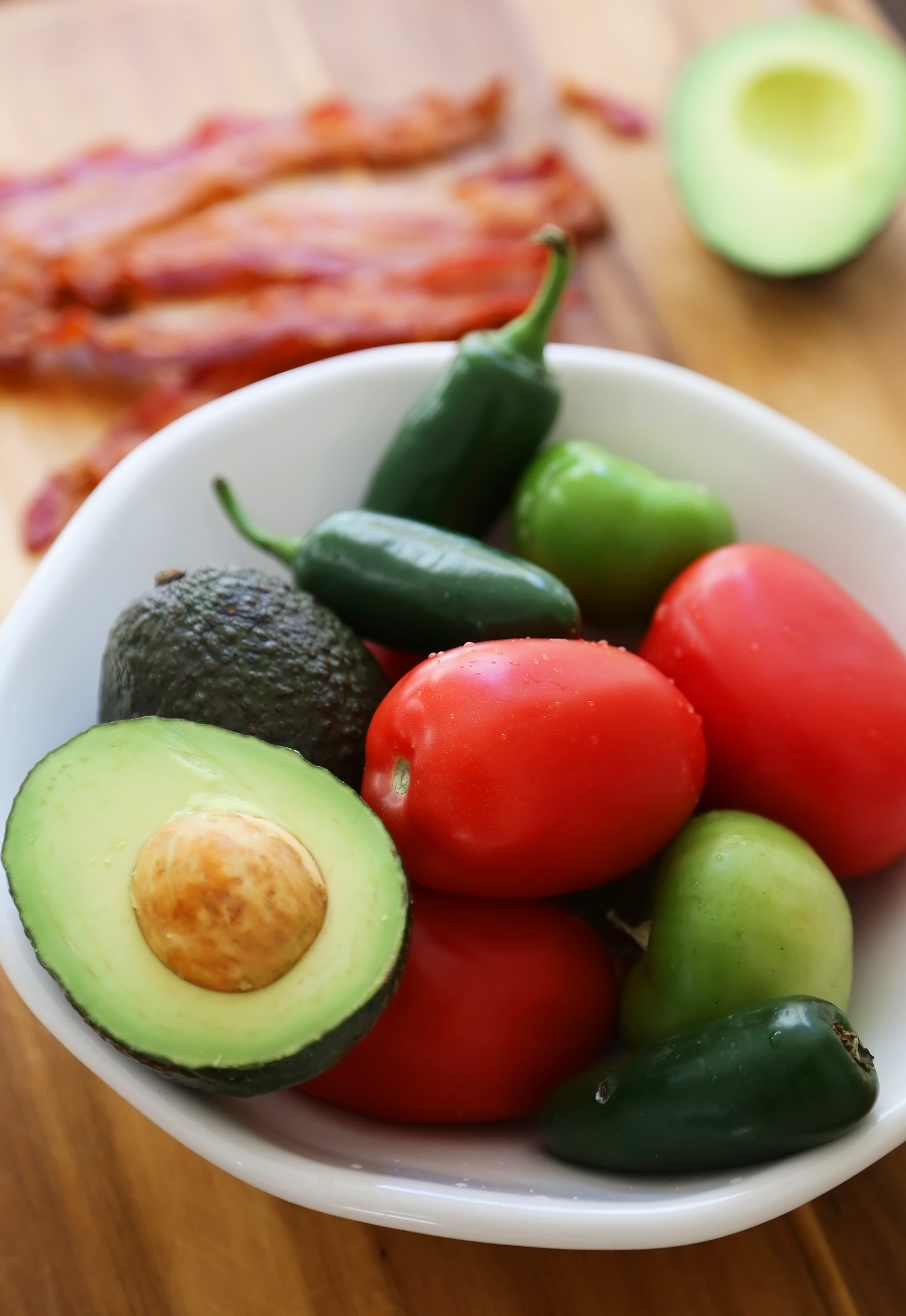 2-Ingredient CrockPot Queso Dip - So easy, cheesy and full of flavor for parties and lazy weekends in. Load it up with bacon, tomatoes, jalapenos and your favorite fixin's! Thecomfortofcooking.com