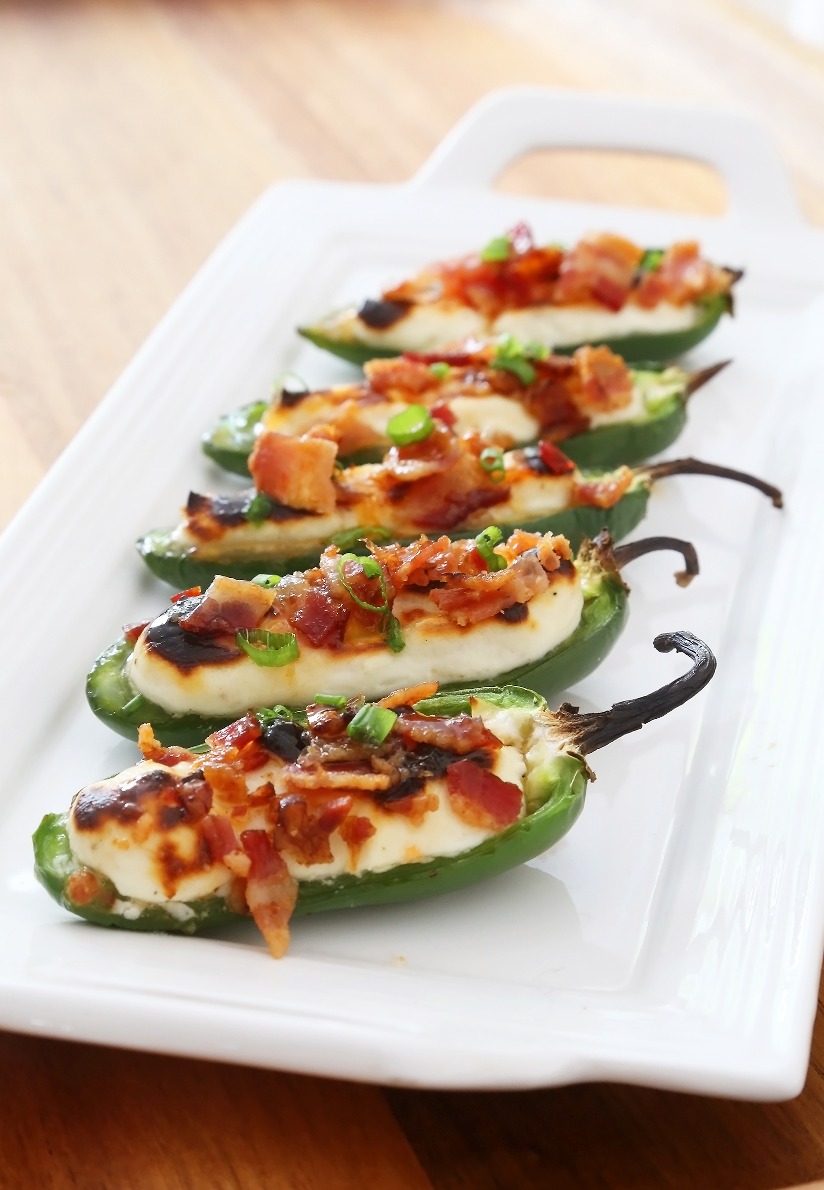 Bacon-Goat Cheese Jalapeño Poppers - Salty-crisp bacon, creamy goat cheese, savory-sweet jelly, all tucked into a roasted jalapeño! Thecomfortofcooking.com