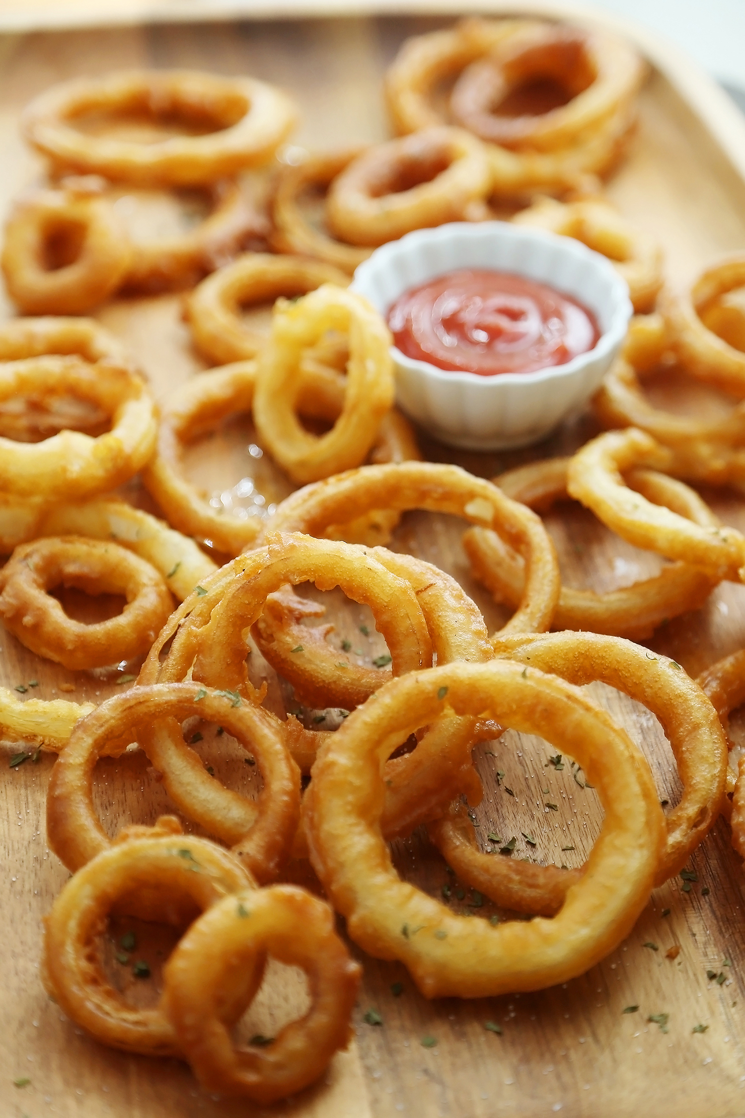 Foolproof Crispy Onion Rings - Snack on a stack of these crispy, salty onion rings! Best-ever recipe for the perfect game-day and family night comfort food! thecomfortofcooking.com