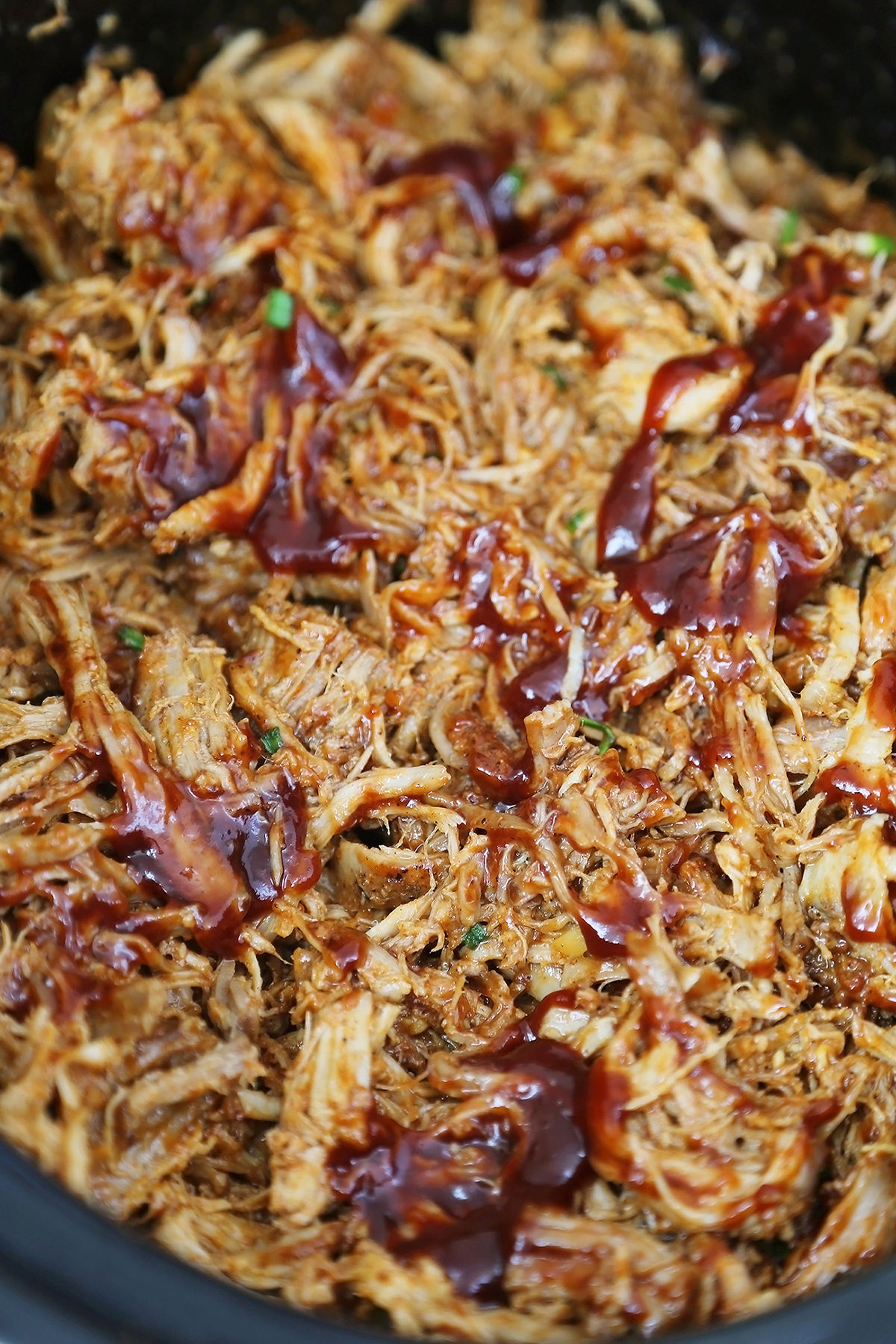 Slow Cooker Apple Cider BBQ Pulled Pork - Our best-ever pulled pork with a tangy, sweet apple cider BBQ sauce! Perfect slow cooker food for weeknight dinners or hungry crowds. thecomfortofcooking.com