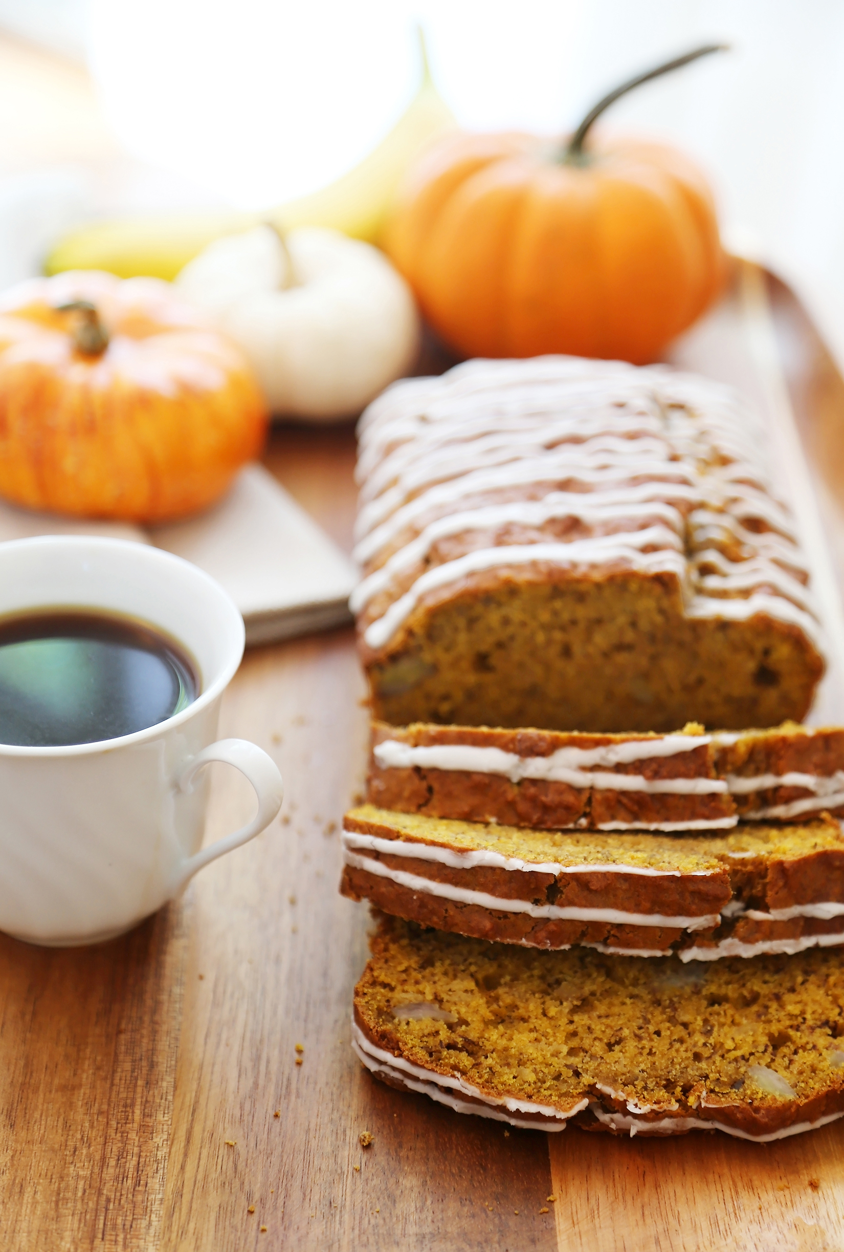 Pumpkin Banana Bread with Vanilla Glaze - Super moist, fluffy pumpkin-banana bread easily baked from scratch! Perfect for gifting or enjoying for breakfast, brunch or dessert. Thecomfortofcooking.com