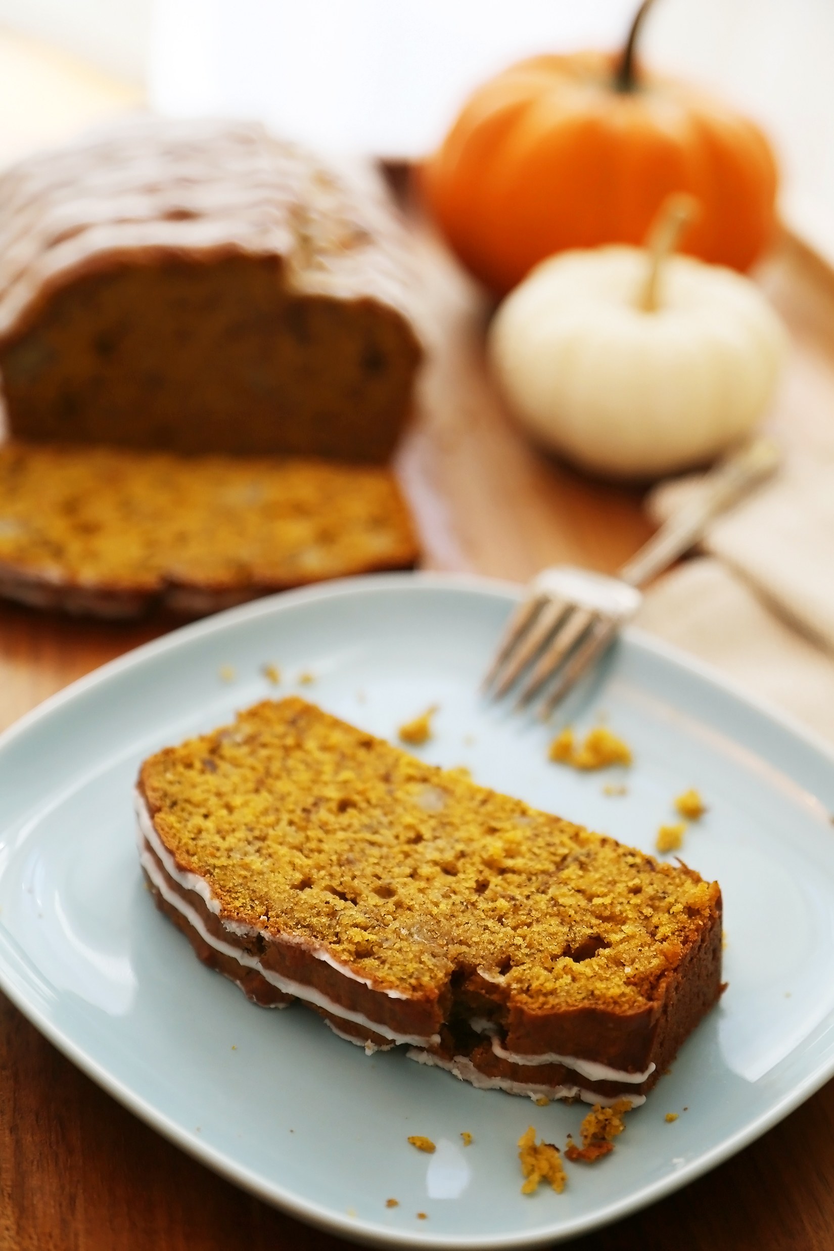 Pumpkin Banana Bread with Vanilla Glaze - Super moist, fluffy pumpkin-banana bread easily baked from scratch! Perfect for gifting or enjoying for breakfast, brunch or dessert. Thecomfortofcooking.com