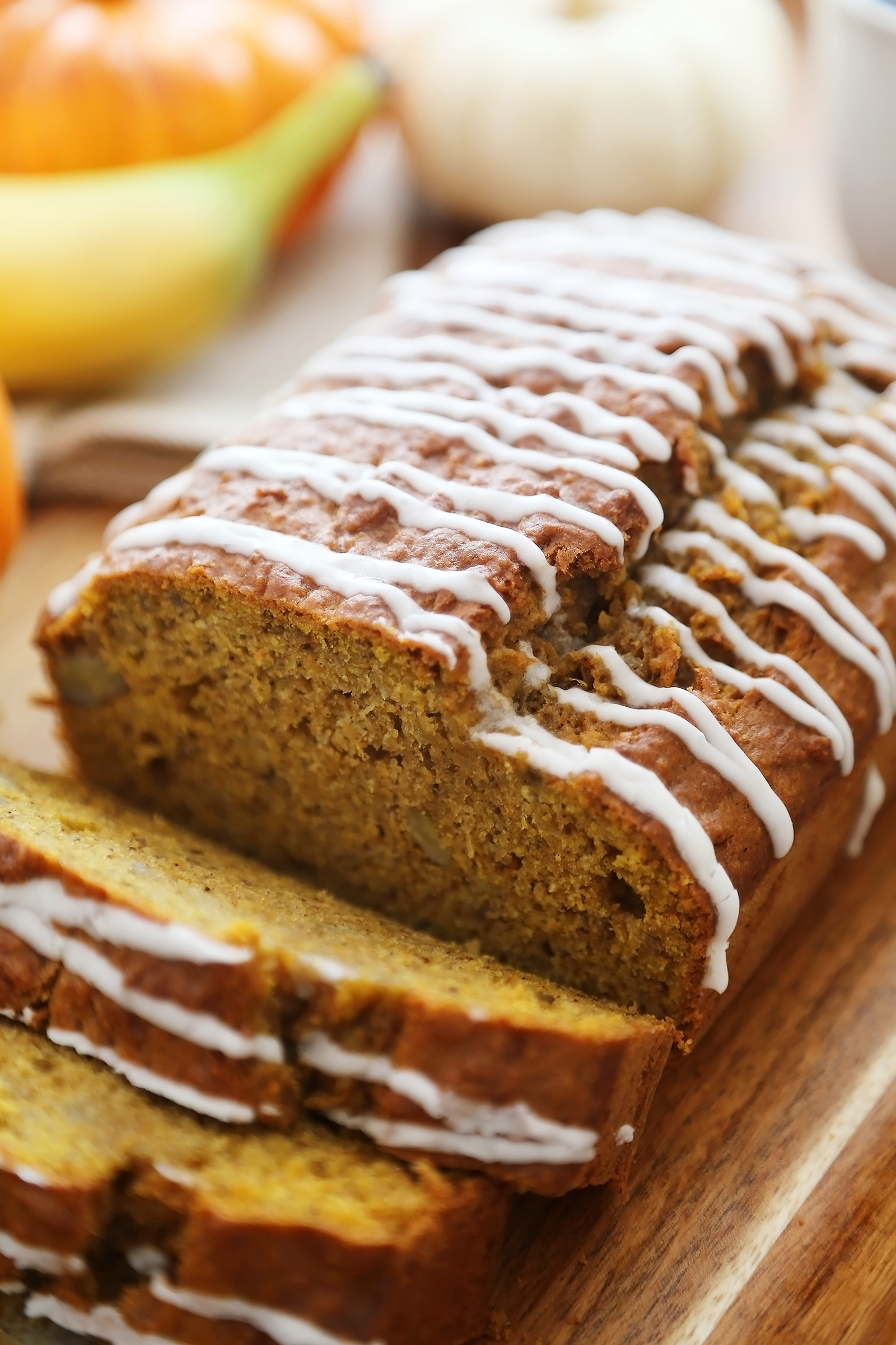 Pumpkin Banana Bread with Vanilla Glaze - Super moist, fluffy pumpkin-banana bread easily baked from scratch! Perfect for gifting or enjoying for breakfast, brunch or dessert. Thecomfortofcooking.com