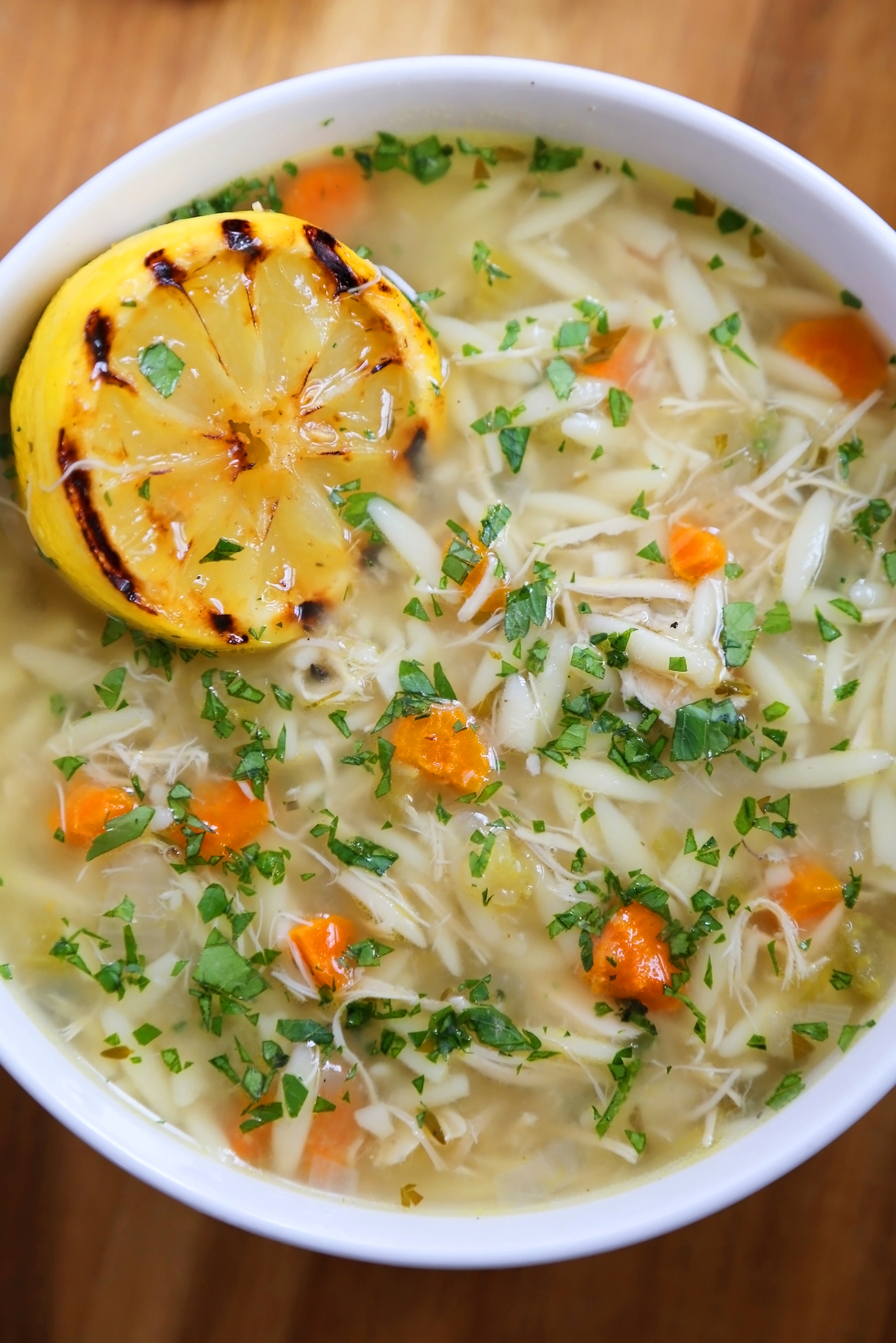 Lemon Orzo Chicken Soup - Full of veggies, tender orzo and fresh lemon juice, the bright flavors and hot broth are full of comforting goodness. Thecomfortofcooking.com