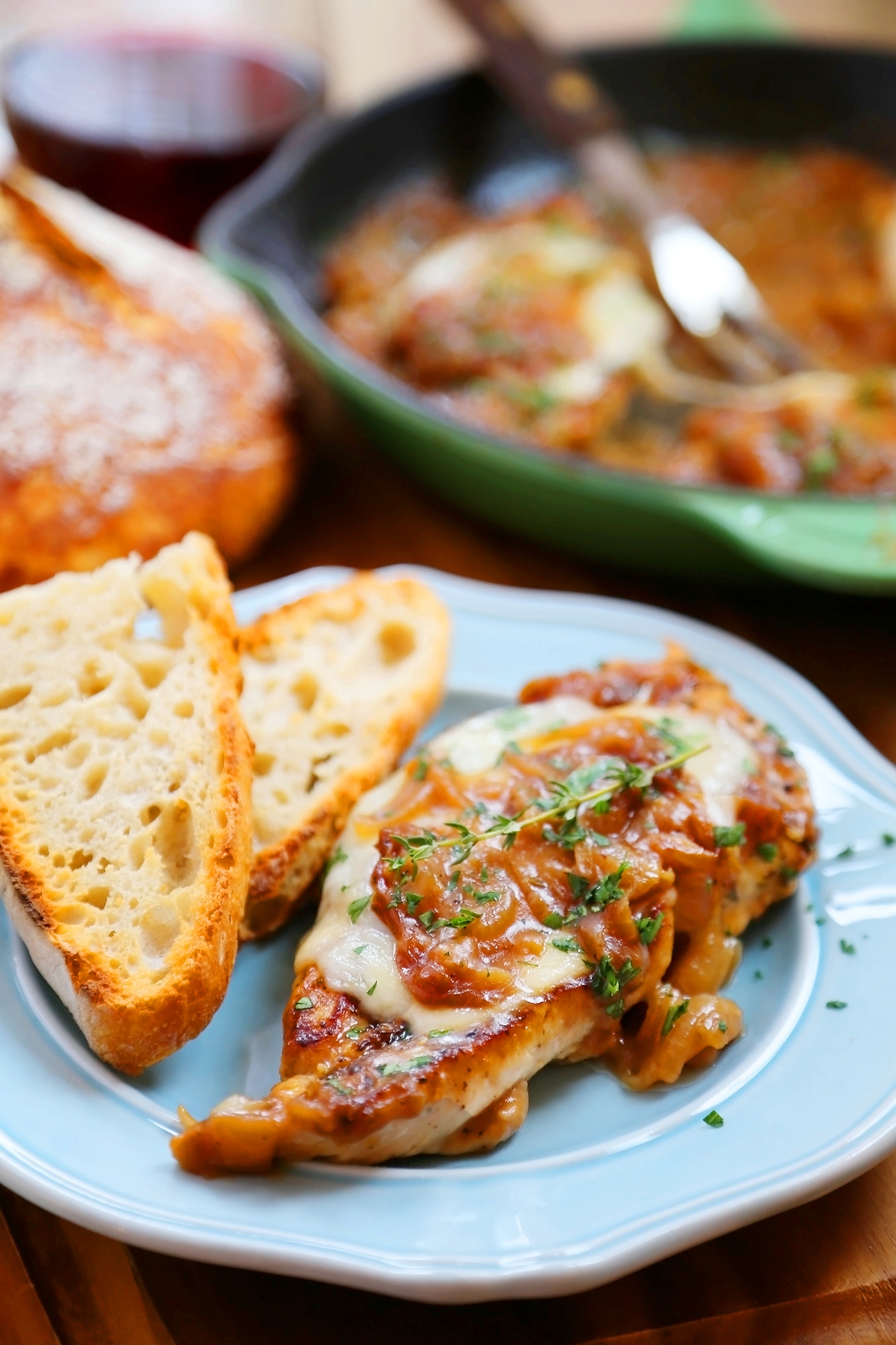 Skillet French Onion Chicken - Saucy, melt-in-your-mouth French onion chicken smothered in caramelized onion gravy, topped with melted cheese. Thecomfortofcooking.com