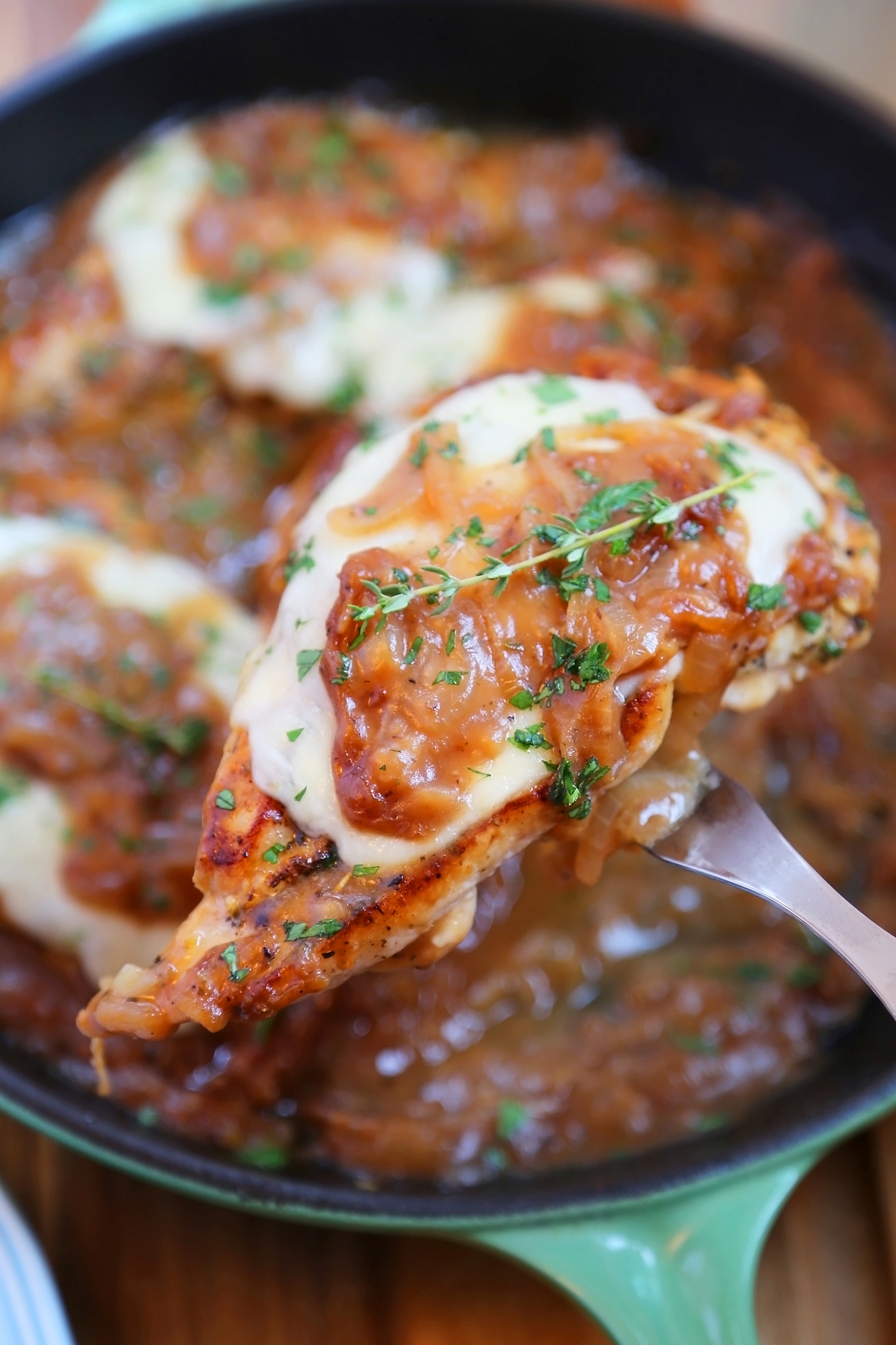 Skillet French Onion Chicken - Saucy, melt-in-your-mouth French onion chicken smothered in caramelized onion gravy, topped with melted cheese. Thecomfortofcooking.com