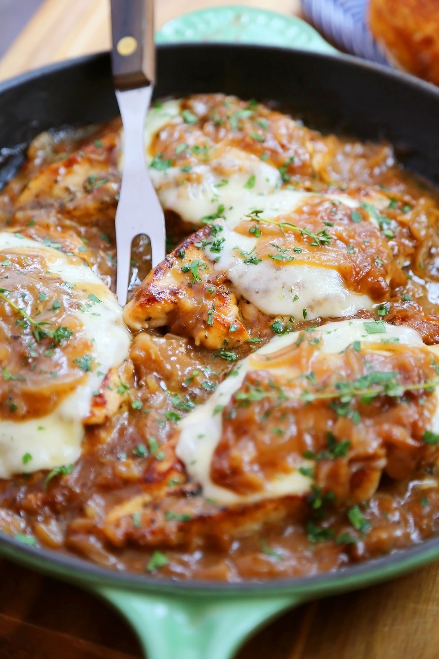 Skillet French Onion Chicken - Saucy, melt-in-your-mouth French onion chicken smothered in caramelized onion gravy, topped with melted cheese. Thecomfortofcooking.com