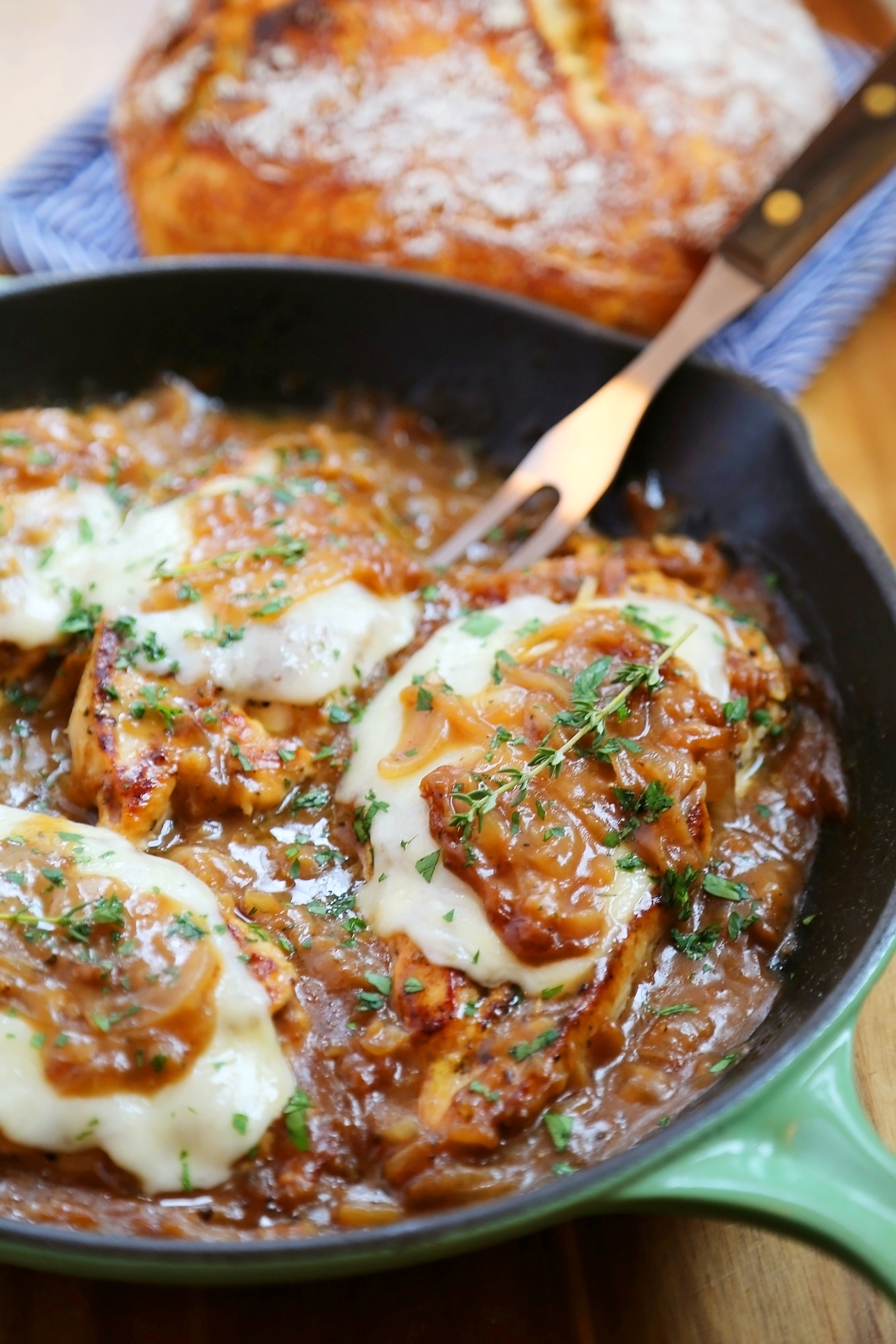 Skillet French Onion Chicken - Saucy, melt-in-your-mouth French onion chicken smothered in caramelized onion gravy, topped with melted cheese. Thecomfortofcooking.com