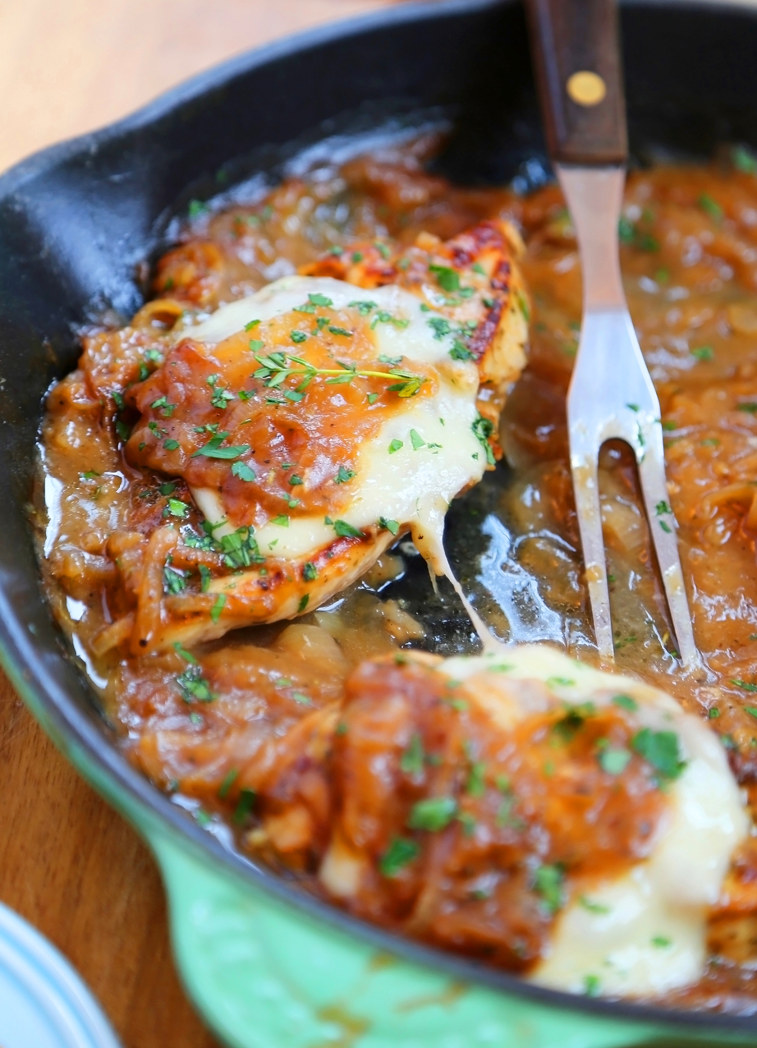 Skillet French Onion Chicken - Saucy, melt-in-your-mouth French onion chicken smothered in caramelized onion gravy, topped with melted cheese. Thecomfortofcooking.com