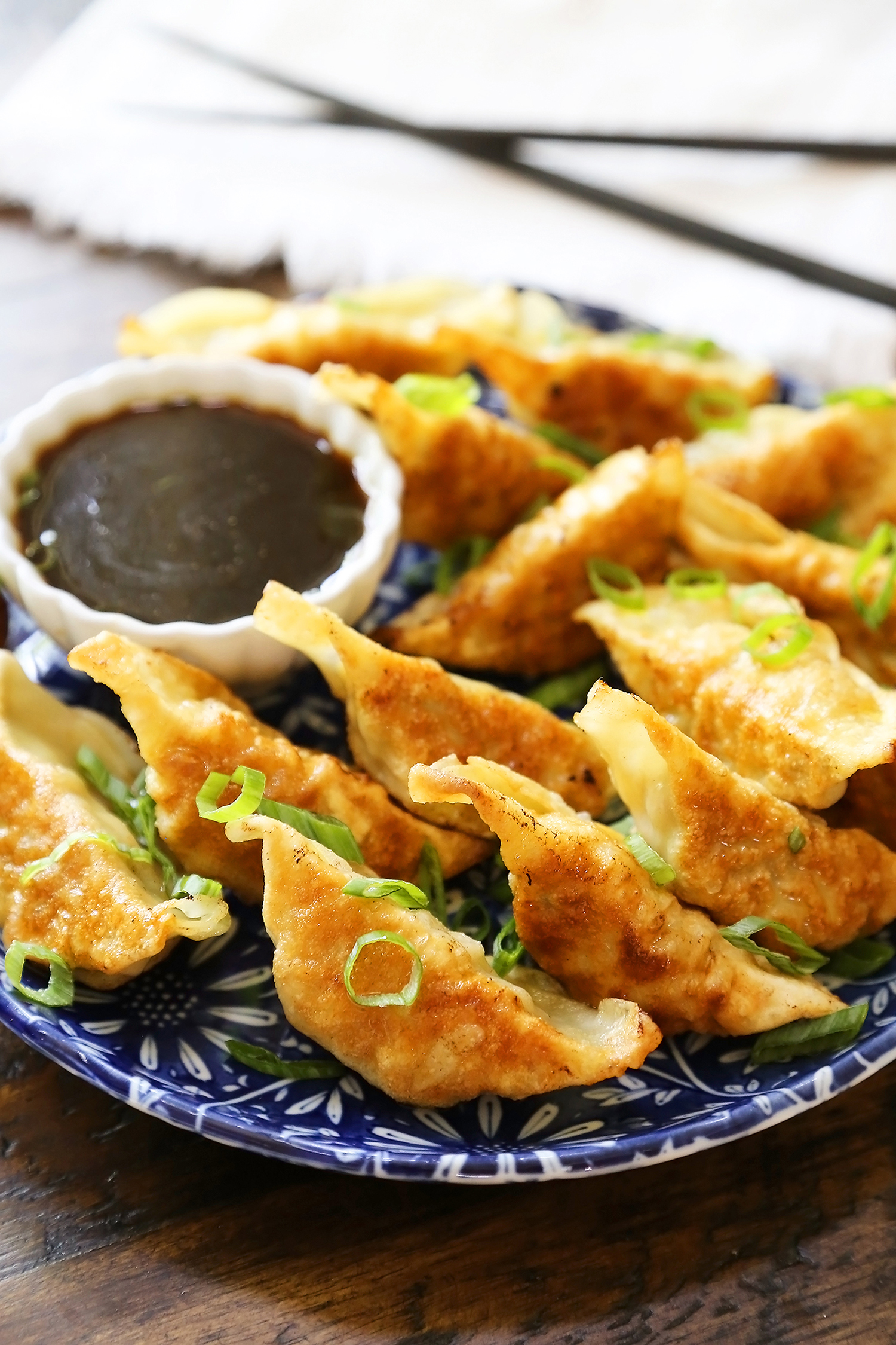 Easy Asian Dumplings with Soy-Ginger Dipping Sauce - Crispy, tender steamed potstickers, made easily in one skillet! thecomfortofcooking.com