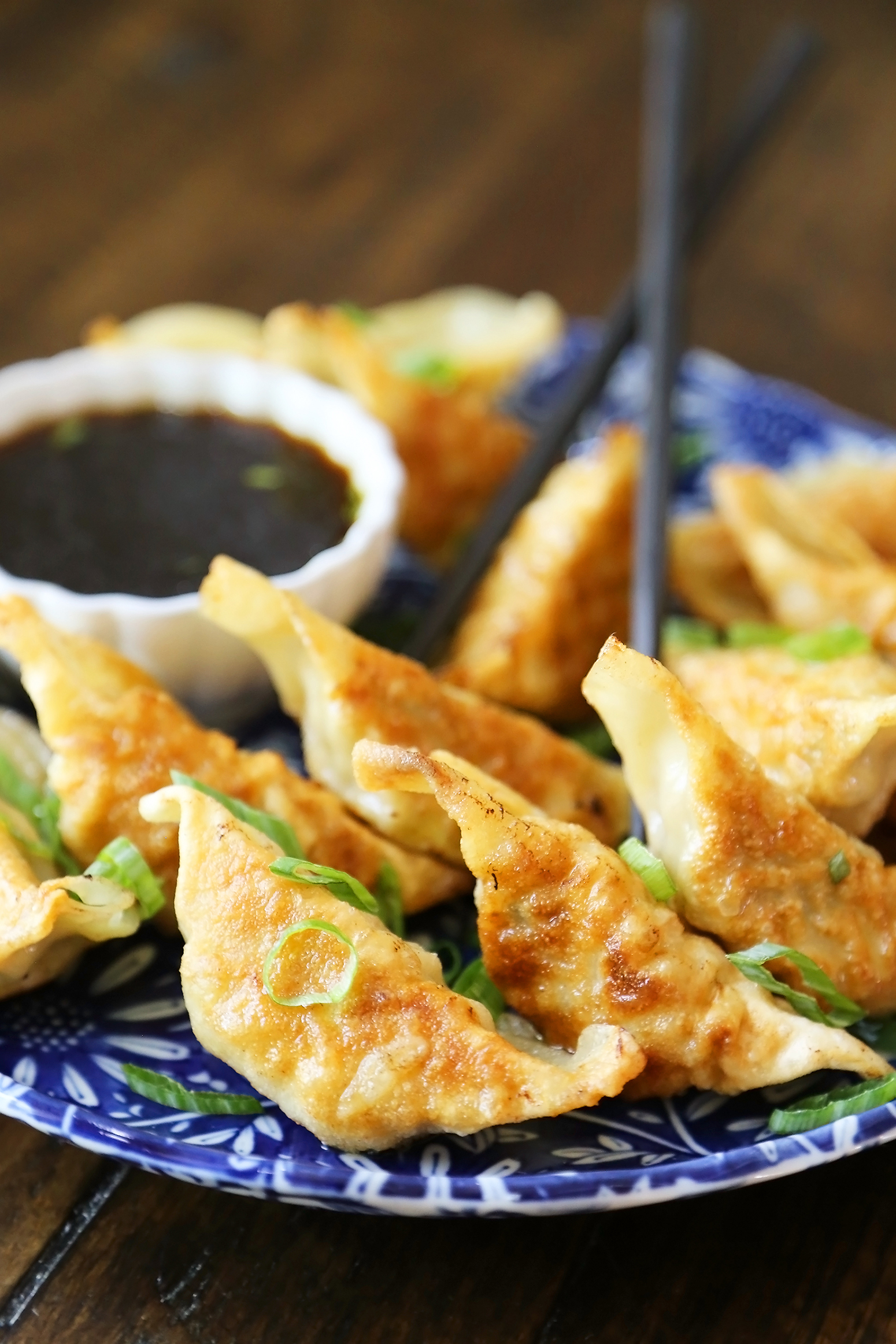 Easy Asian Dumplings with Soy-Ginger Dipping Sauce - Crispy, tender steamed potstickers, made easily in one skillet! thecomfortofcooking.com