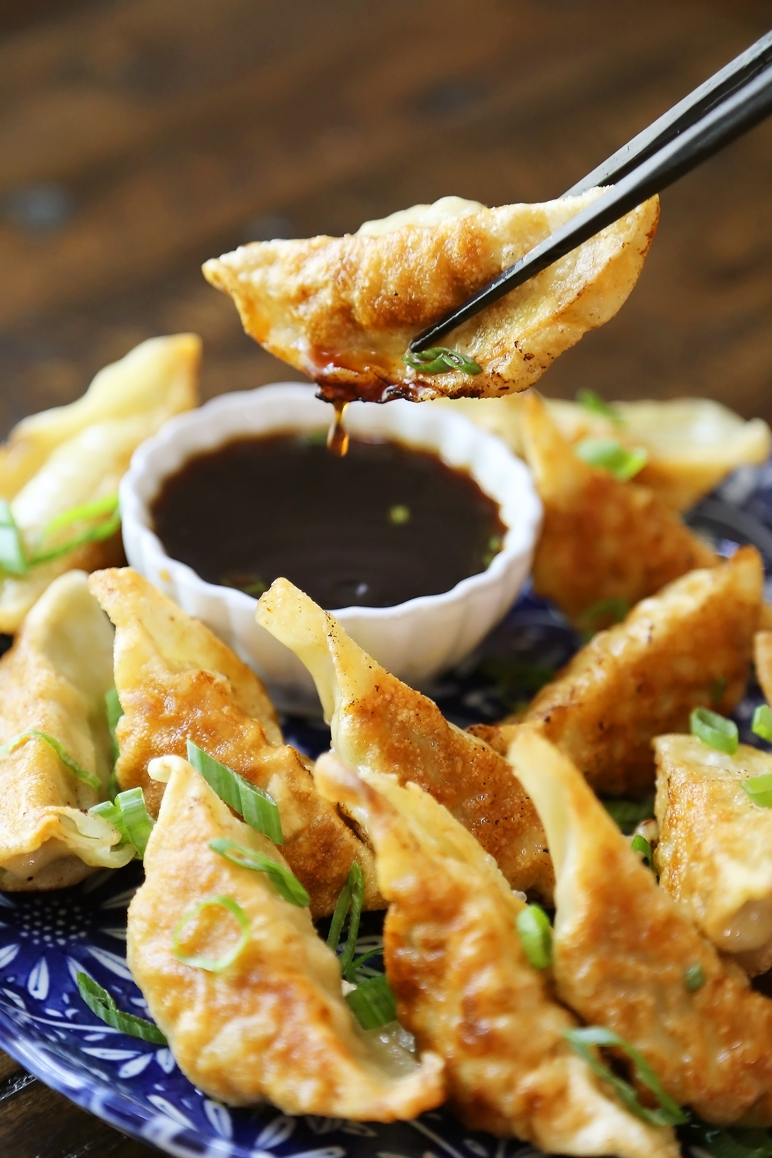 Easy Asian Dumplings with Soy-Ginger Dipping Sauce - Crispy, tender steamed potstickers, made easily in one skillet! thecomfortofcooking.com