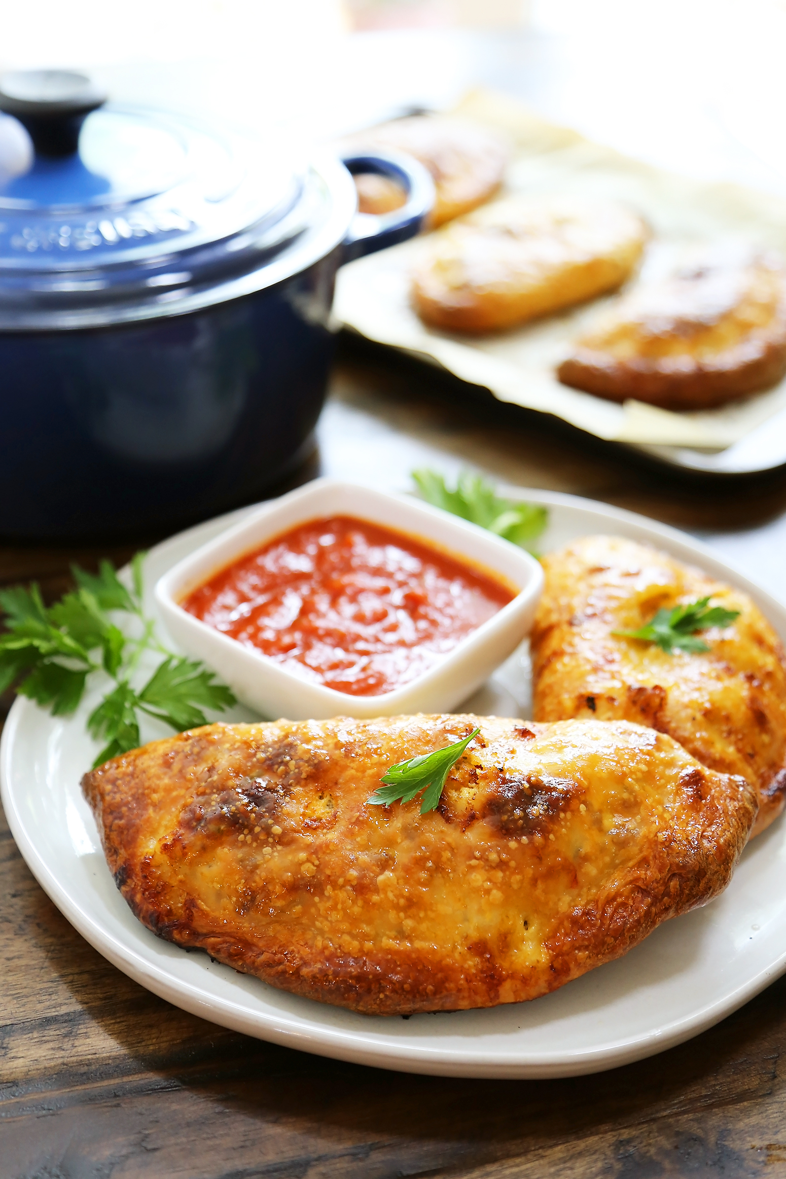 Sausage, Ricotta and Veggie Calzones - Crispy, golden calzones with easy, family friendly ingredients. So delicious dunked in marinara sauce! thecomfortofcooking.com