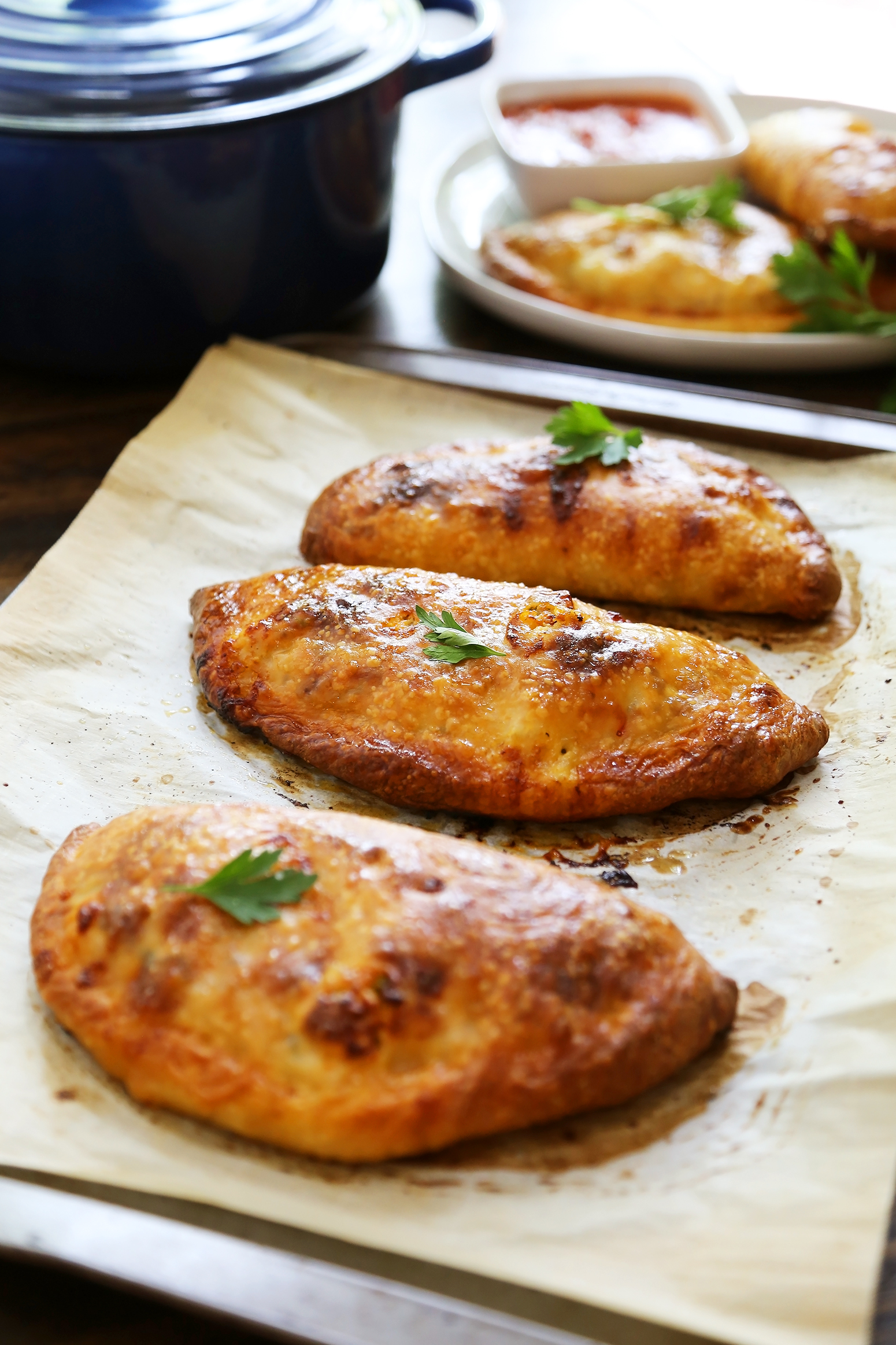 Sausage, Ricotta and Veggie Calzones - Crispy, golden calzones with easy, family friendly ingredients. So delicious dunked in marinara sauce! thecomfortofcooking.com