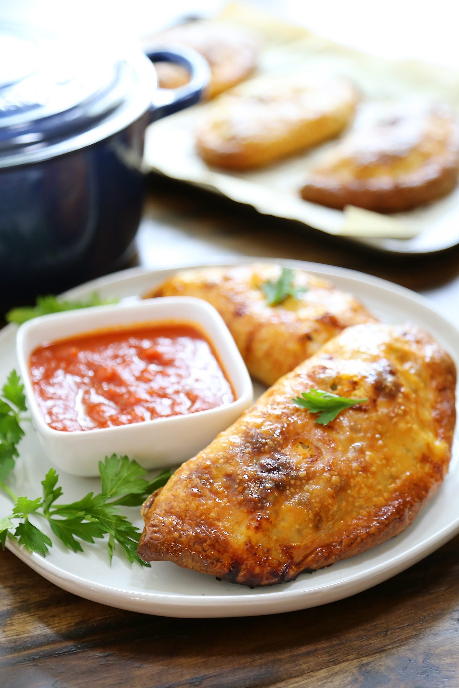 Sausage, Ricotta and Veggie Calzones - Crispy, golden calzones with easy, family friendly ingredients. So delicious dunked in marinara sauce! thecomfortofcooking.com