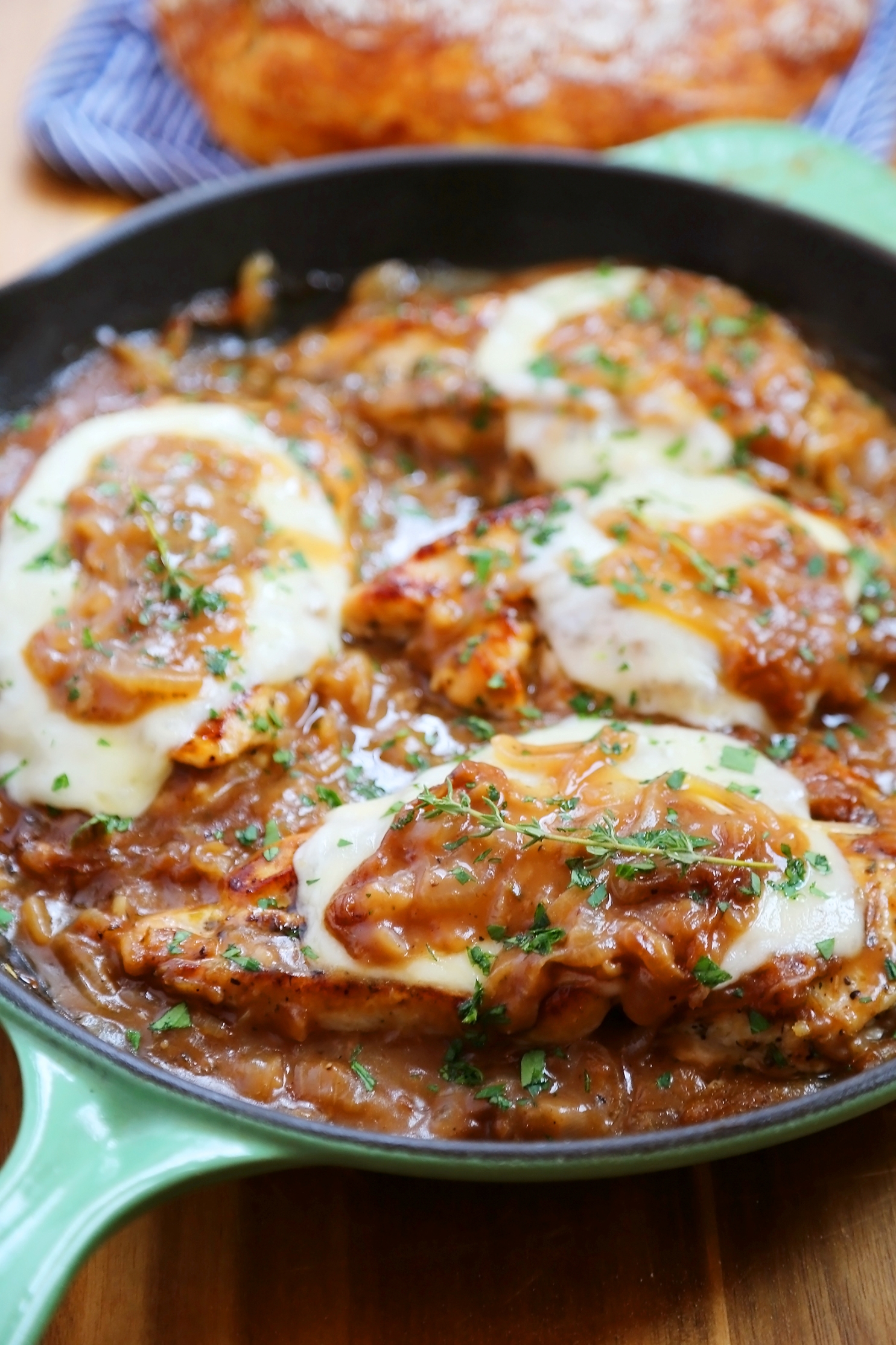 Skillet French Onion Chicken - Saucy, melt-in-your-mouth French onion chicken smothered in caramelized onion gravy, topped with melted cheese. Thecomfortofcooking.com